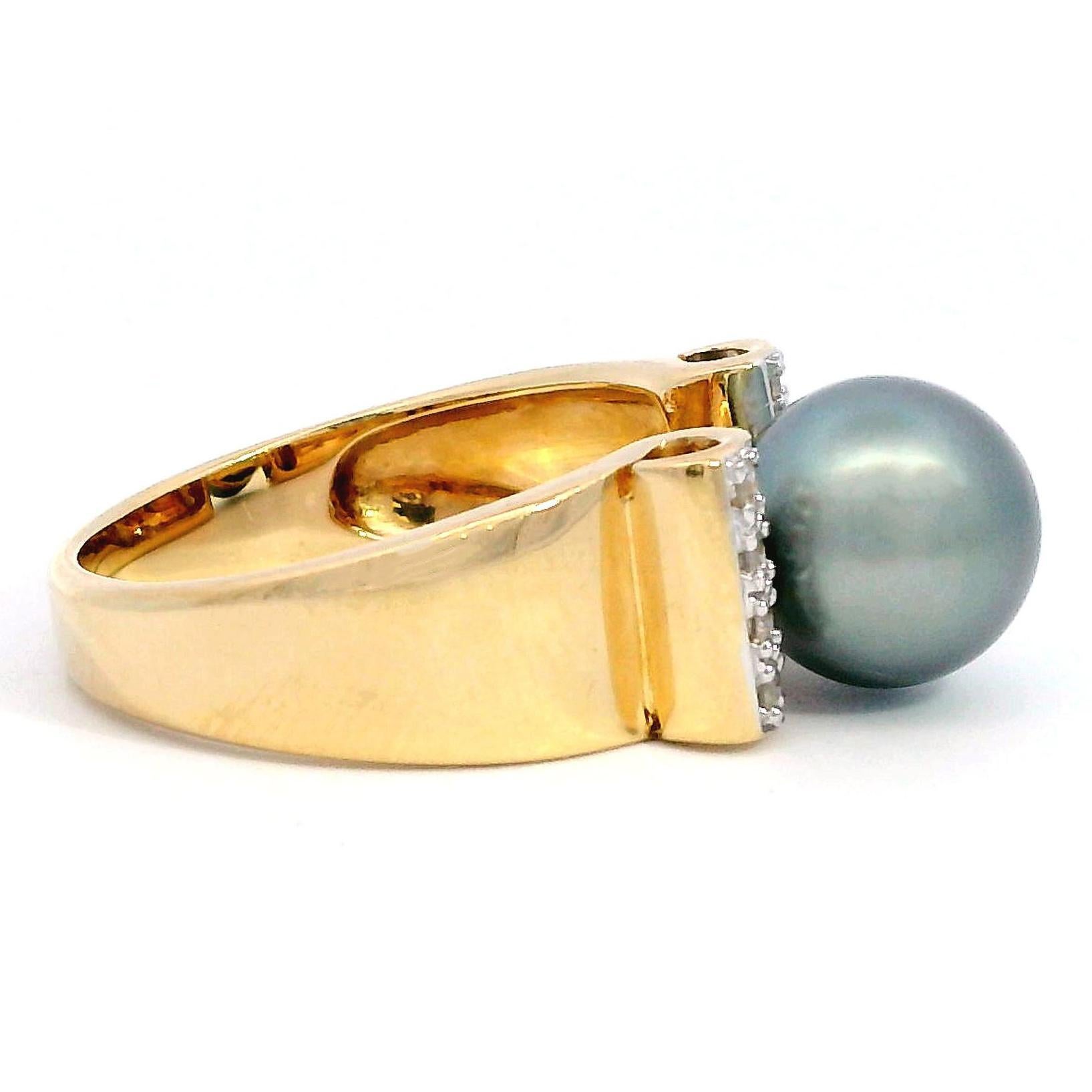 his striking ring showcases a lustrous black pearl, perfectly centered and flanked by rows of sparkling white diamonds. The pearl's deep hue is beautifully offset by the brilliance of the diamonds, creating a captivating focal point. The setting is