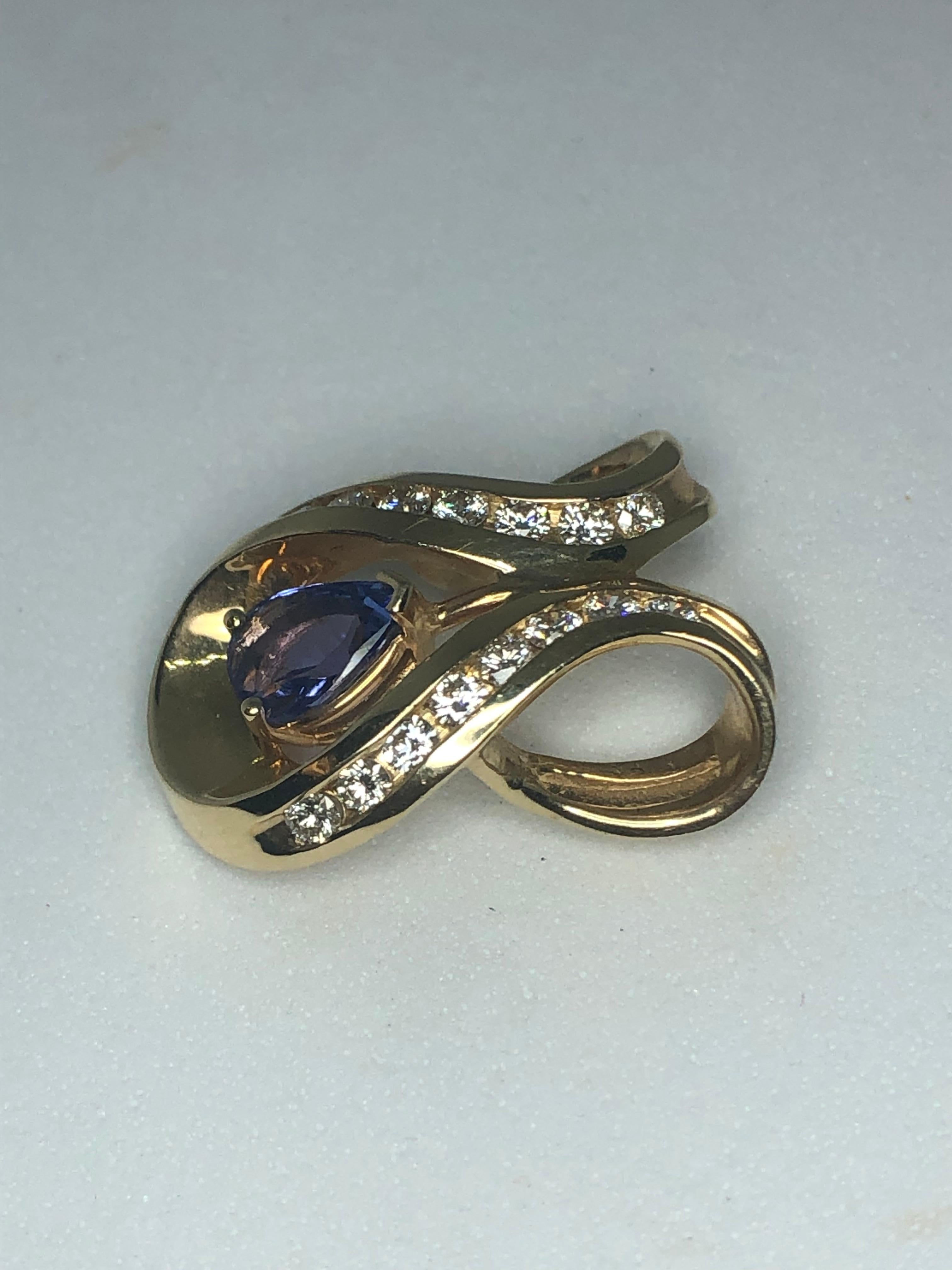 Lady's 14kt yellow gold tanzanite and diamond slide pendant by Cordova. Style #2222, 1 - pear shaped tanzanite = .75ct total weight, 16 full cut round diamonds = .48ct, average color G-H, average clarity VS2-SI1, 2.7dwt.