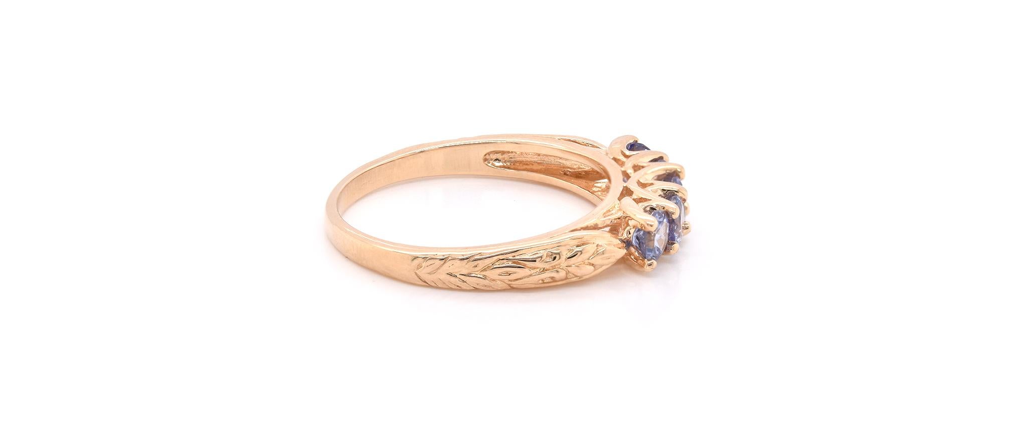 Material: 14k yellow gold
Gemstone: 5 round cut tanzanite’s
Dimensions: ring measures 4.40mm in width
Ring Size: 8 ¾ (please allow two extra shipping days for sizing requests) 
Weight: 4.0 grams