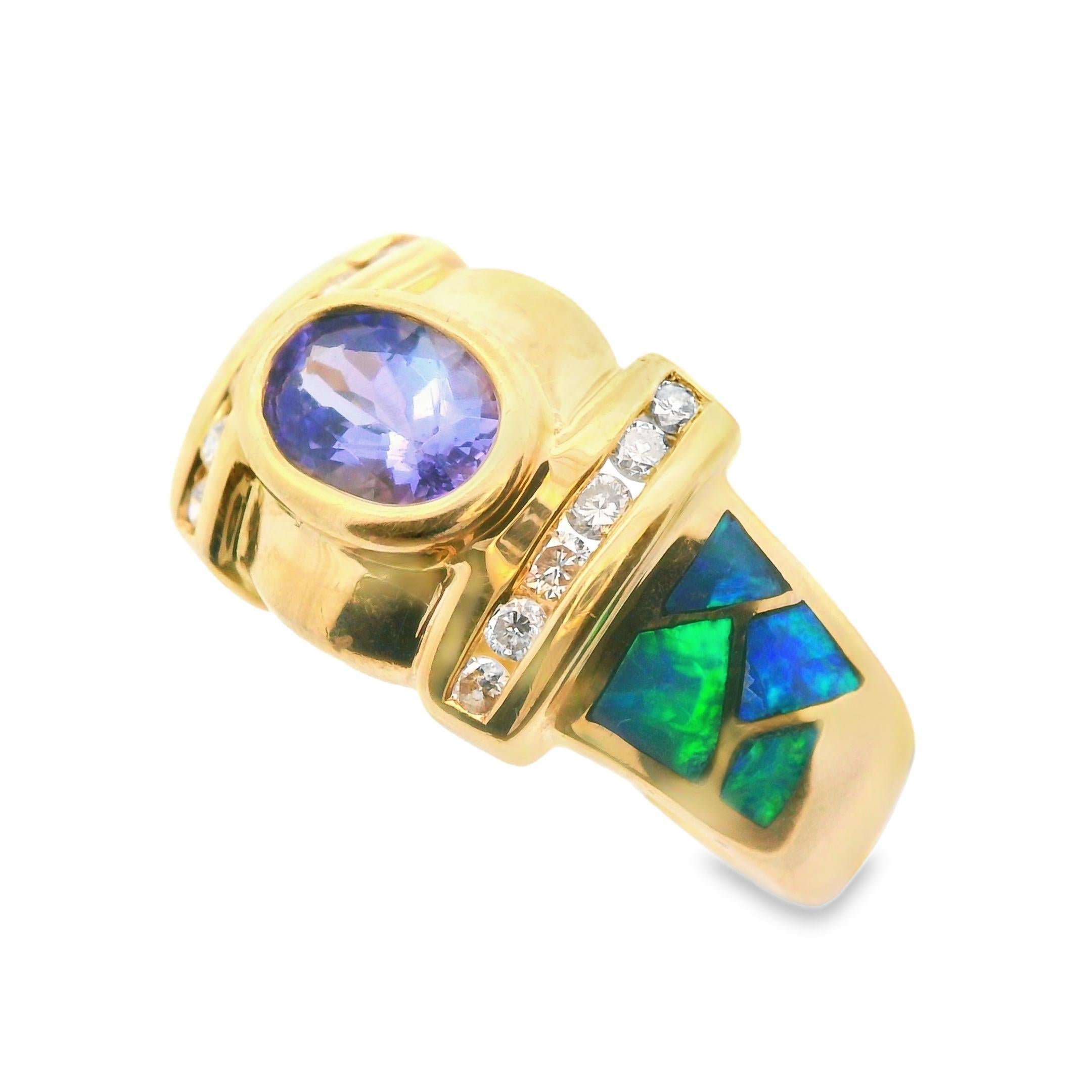 This colorful 14k yellow gold ring is brought to life using a combination of gorgeous inlay opal, sparely diamond and violet tanzanite. The center of the ring features a bold 14k yellow gold oval background. Set in the center is a stunning oval