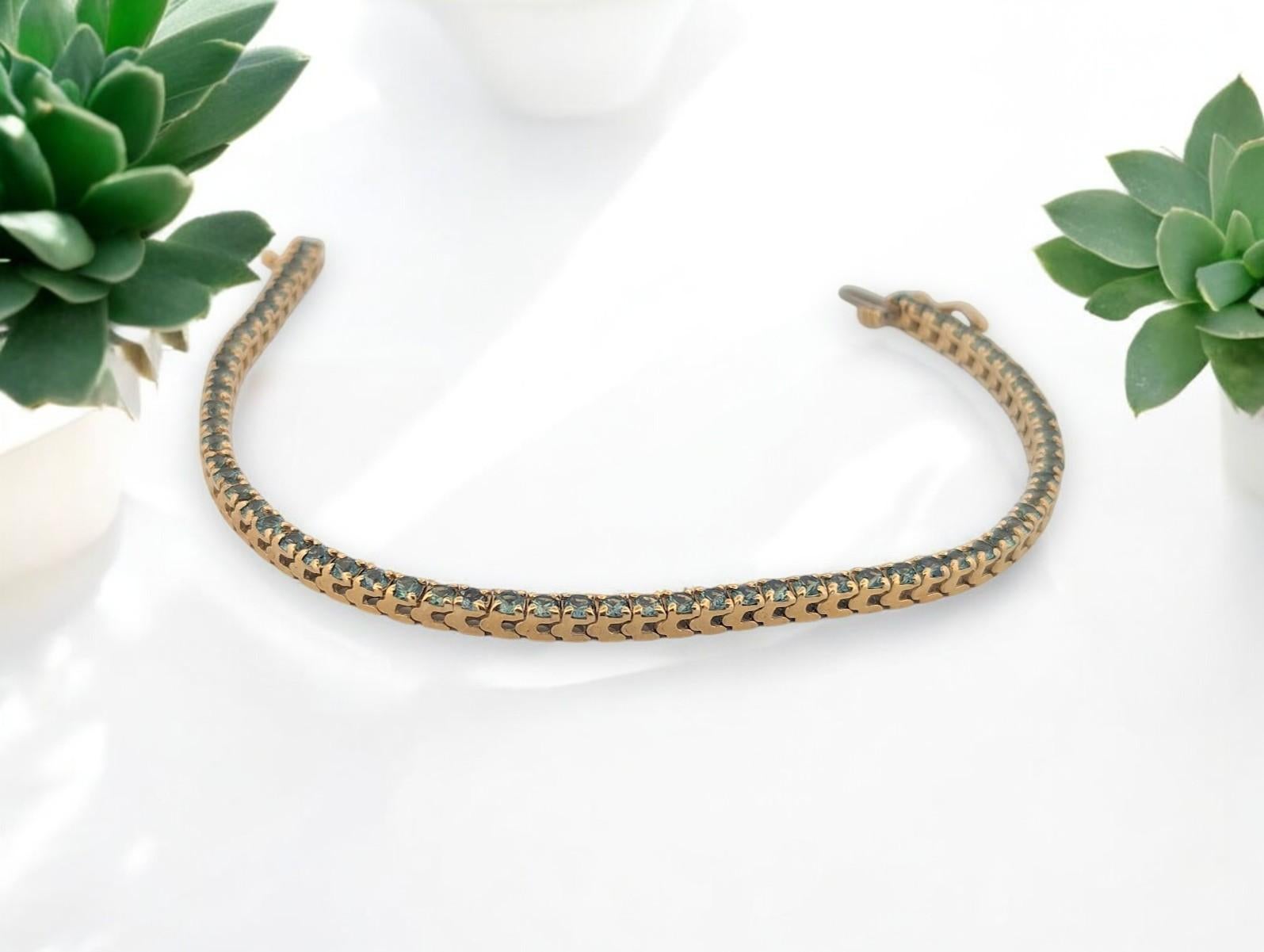 This exquisite 14K yellow gold tennis bracelet features 2.39 carats of natural Tanzanite, a rare gemstone known for its captivating blue-violet hue. Each stone is meticulously set in a classic prong setting, allowing light to enhance the gem’s