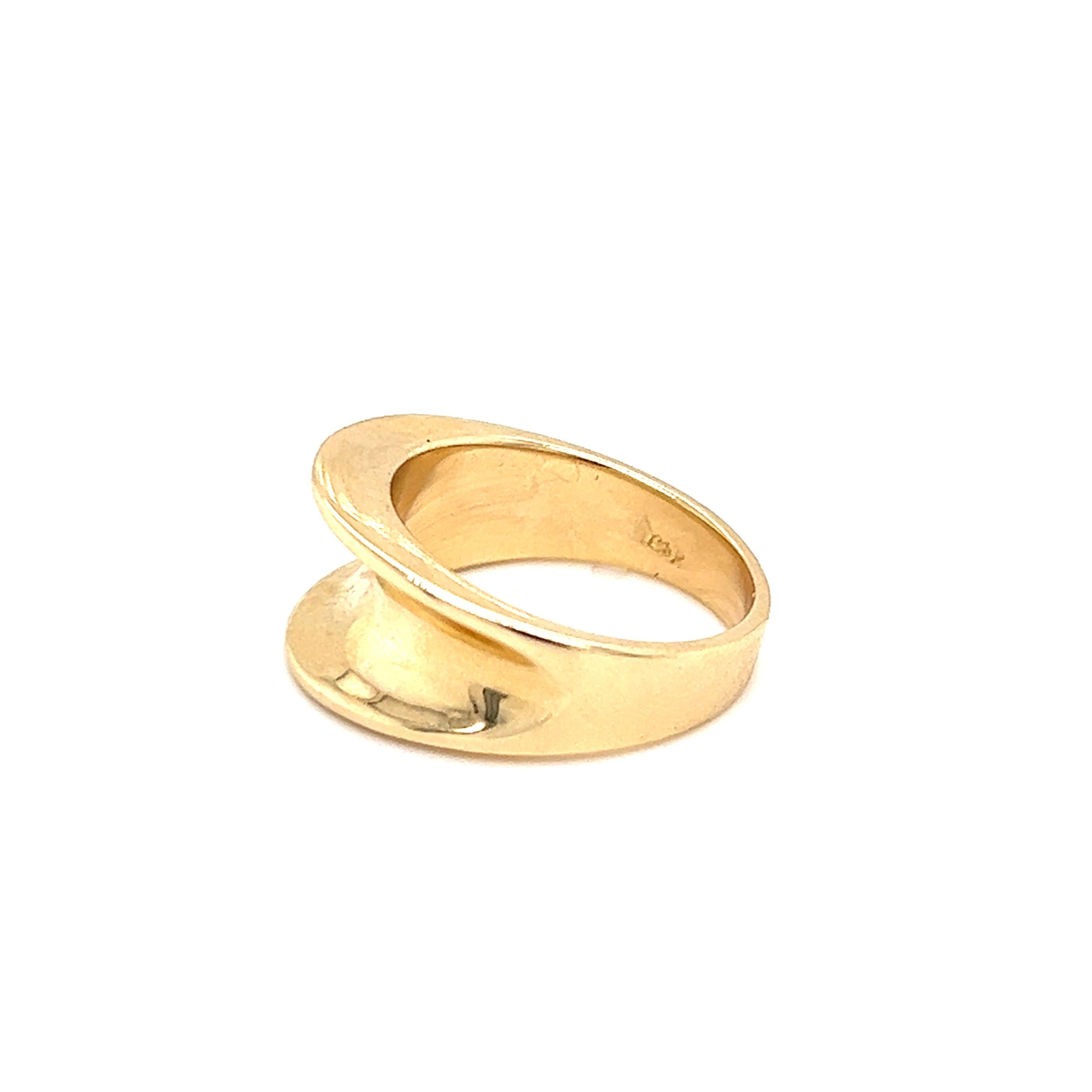One 14 karat yellow gold (stamped 14k) tapered concave ring measuring 9.94mm near the top of the ring and tapers to 3.84mm at the base of the shank.  The ring is a finger size 6.5 and is resizable.  