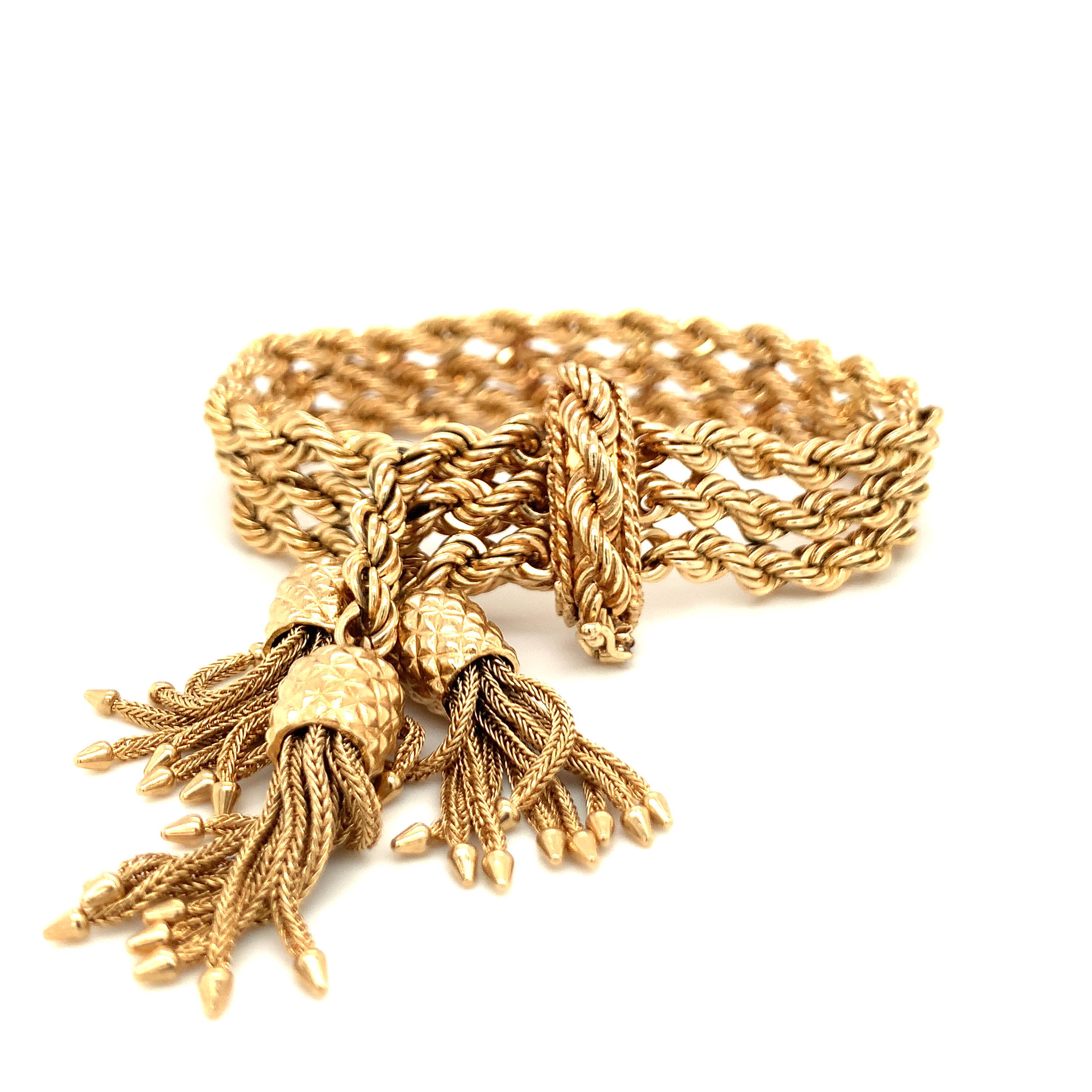 One 14K yellow gold bracelet composed of 3 rope twist chain links with 3 suspended tassle charms. 14k-yg bracelet composed of 3 rope twist chain links with 3 suspending tassle charms.

Intricate, playful, attractive.

Metal: 14k Yellow Gold
Circa: