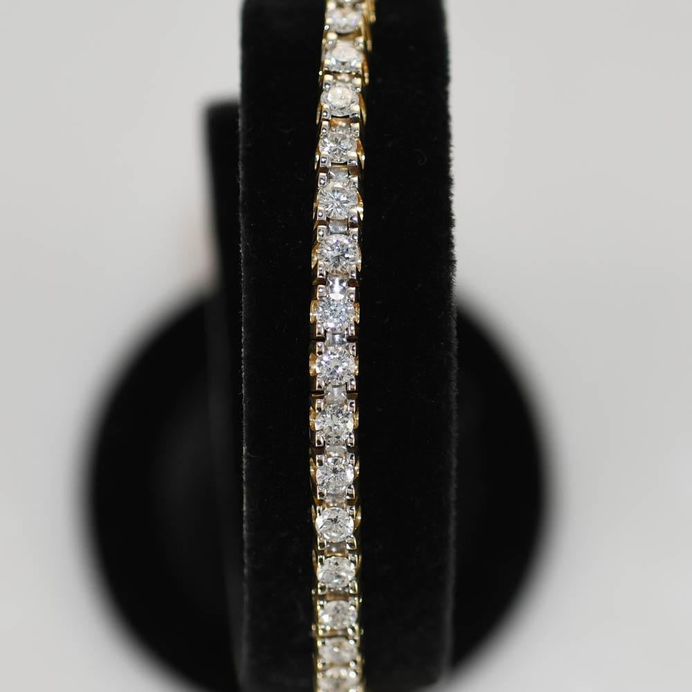 Ladies 14k yellow gold  diamond tennis bracelet.
Stamped 14k and weighs 17.6 grams.
The diamonds are round brilliant cuts, 5.00 total carats, G to H color, Si clarity, good cuts.
The bracelet measures 6 1/2 inches long and 4mm wide.
Comes with