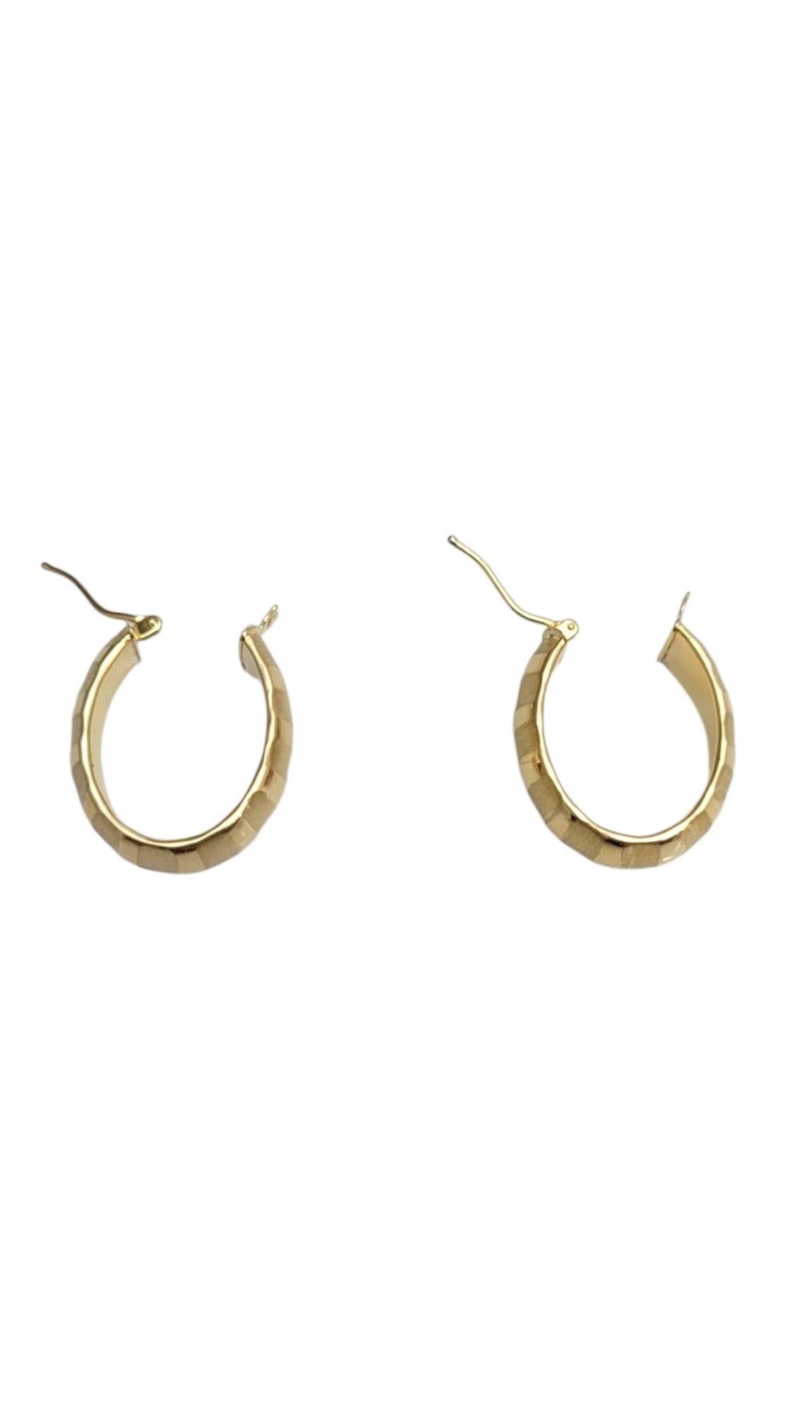 14K Yellow Gold Textured Band Oval Hoops-

Elevate your style with these textured band hoop earrings, crafted in radiant 14k yellow gold. Featuring a unique, detailed finish, these hoops blend classic elegance with a modern twist—perfect for adding