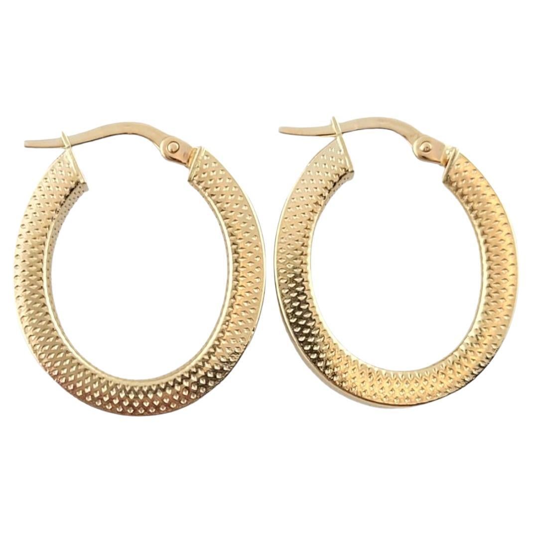 14K Yellow Gold Textured Oval Hoop Earrings #16189 For Sale