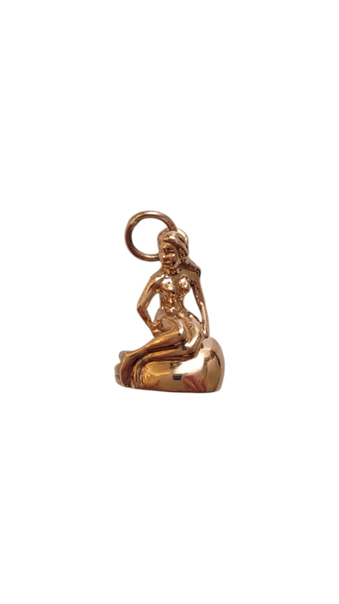 14K Yellow Gold The Little Mermaid Charm-

This mermaid charm is perfect for ocean lovers, and adds a touch of whimsy and elegance to any jewelry collection. A symbol of beauty, mystery, and the wonders of the deep, this charm brings a bit of