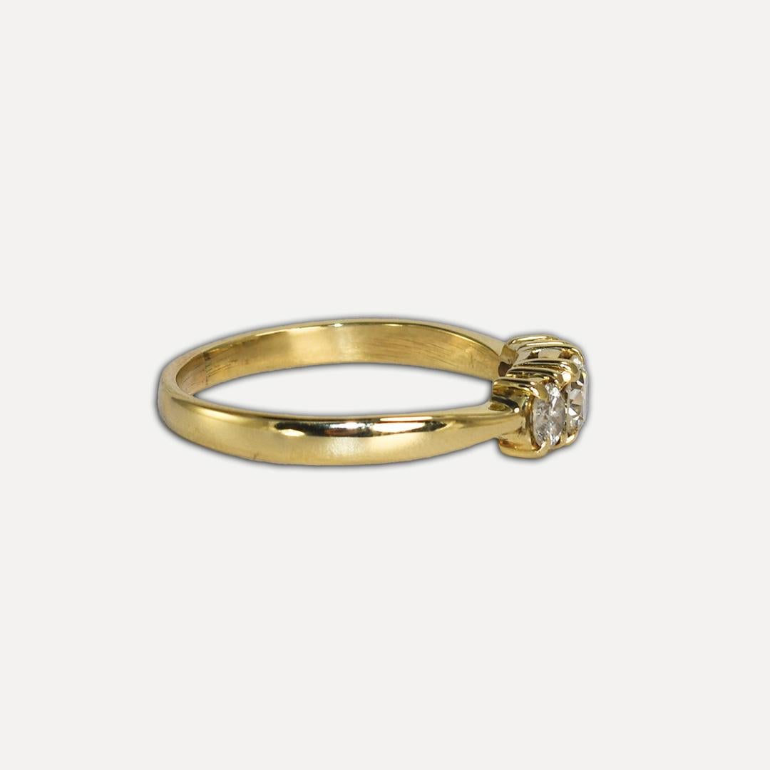 Ladies three diamond ring with 14k yellow gold setting.
Stamped 14k and weighs 2.7 grams.
The center diamond is a 0.30-carat transition cut, J color, Vs2 clarity.
There are two modern brilliant cuts on the sides, .25 total carats, j to k color, and