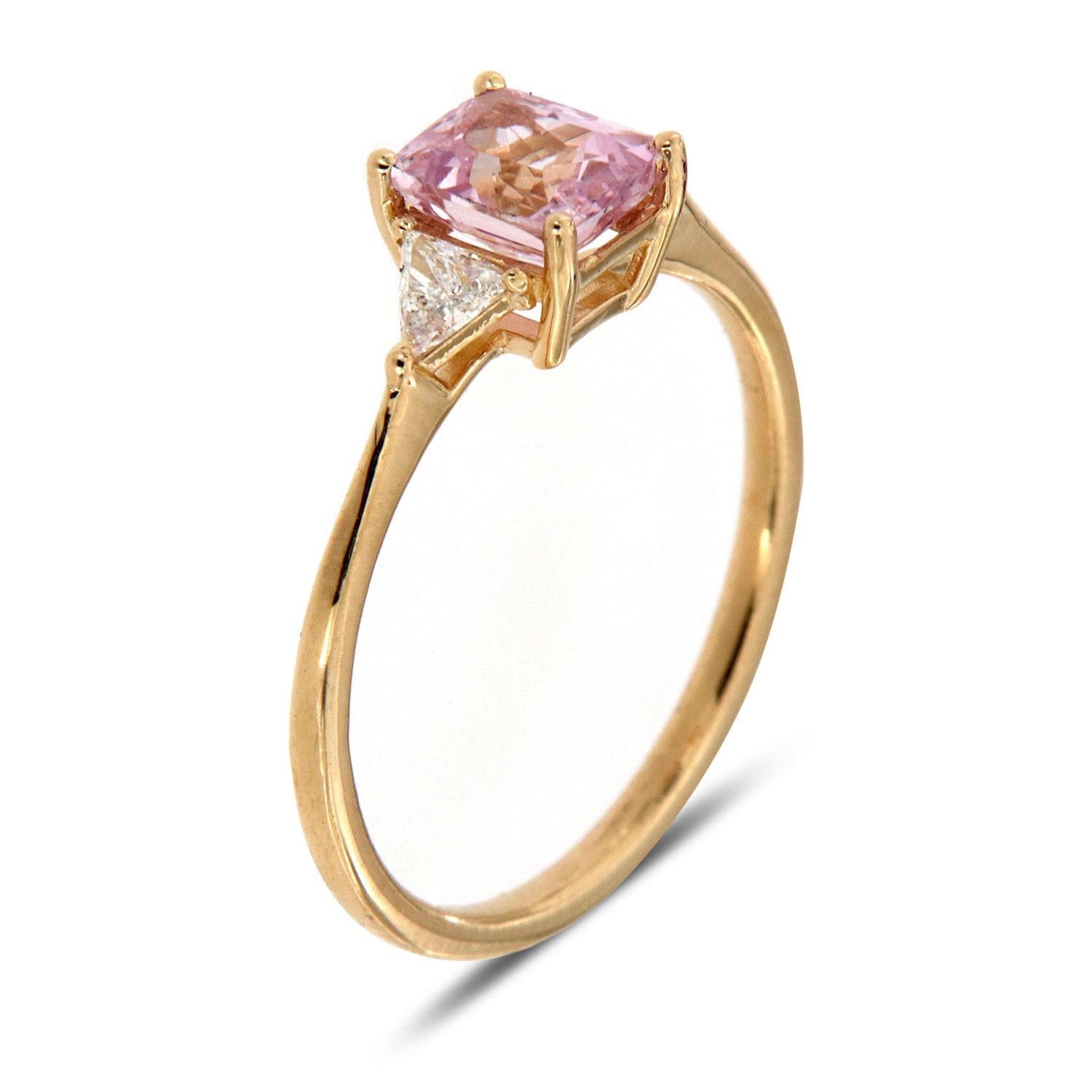 This Classic Three Stone ring features a 0.97 Radaint Shaped Natural unheated Light Pink-Peach color flanked by two perfectly matched Triallion cut diamond weight 0.38 Carat. The ring is 1.4 mm wide, tapering to 3 mm. The ring sizable and can be