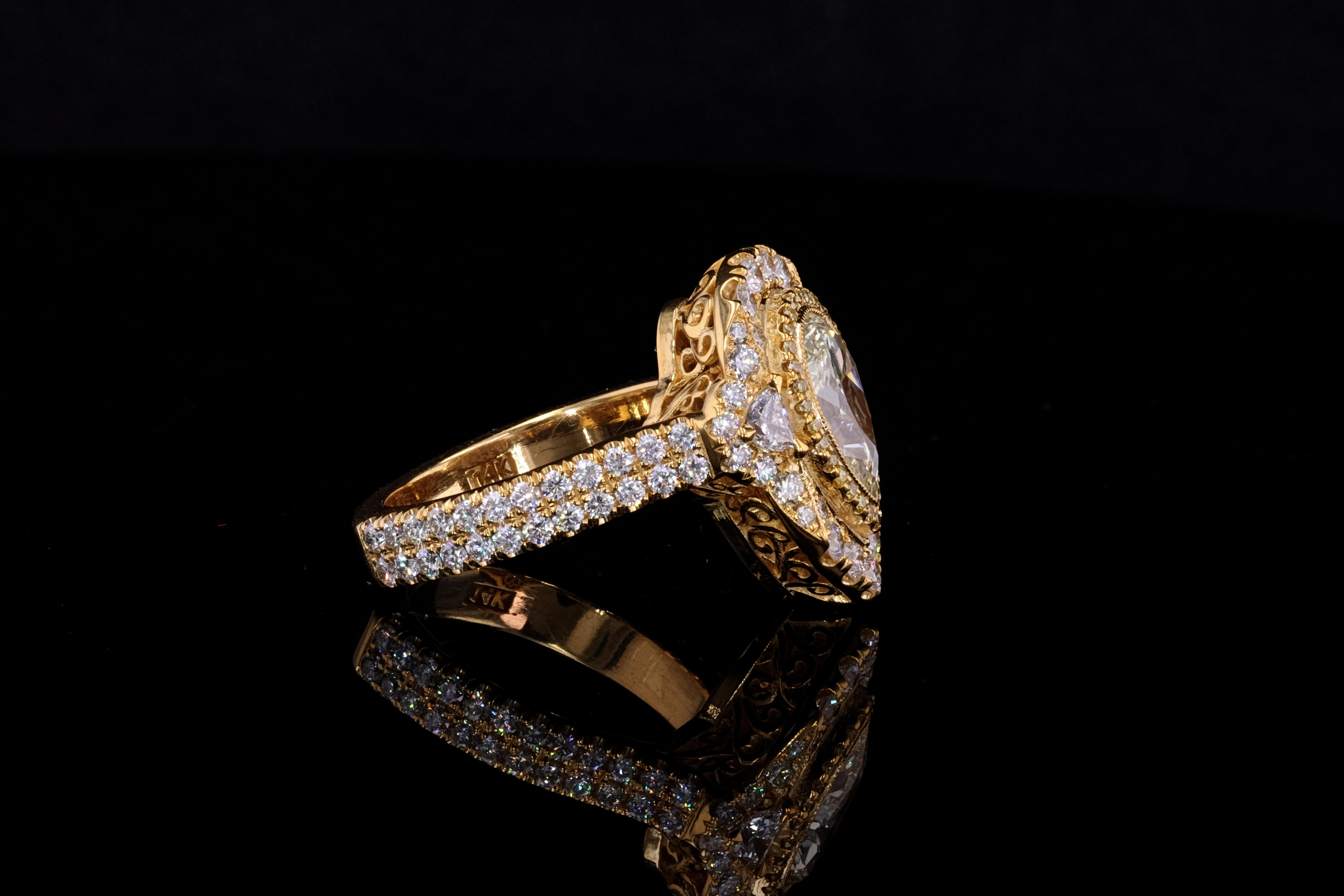 Showcasing a simply beautiful, elegant, and finely detailed ring, center stone is securely bezel set with a Pear Shaped Fancy Light Yellow Diamond, weighing 1.51 carat with two side Half Moon Shaped Diamonds 3-prong set weighing 0.18 total carat
