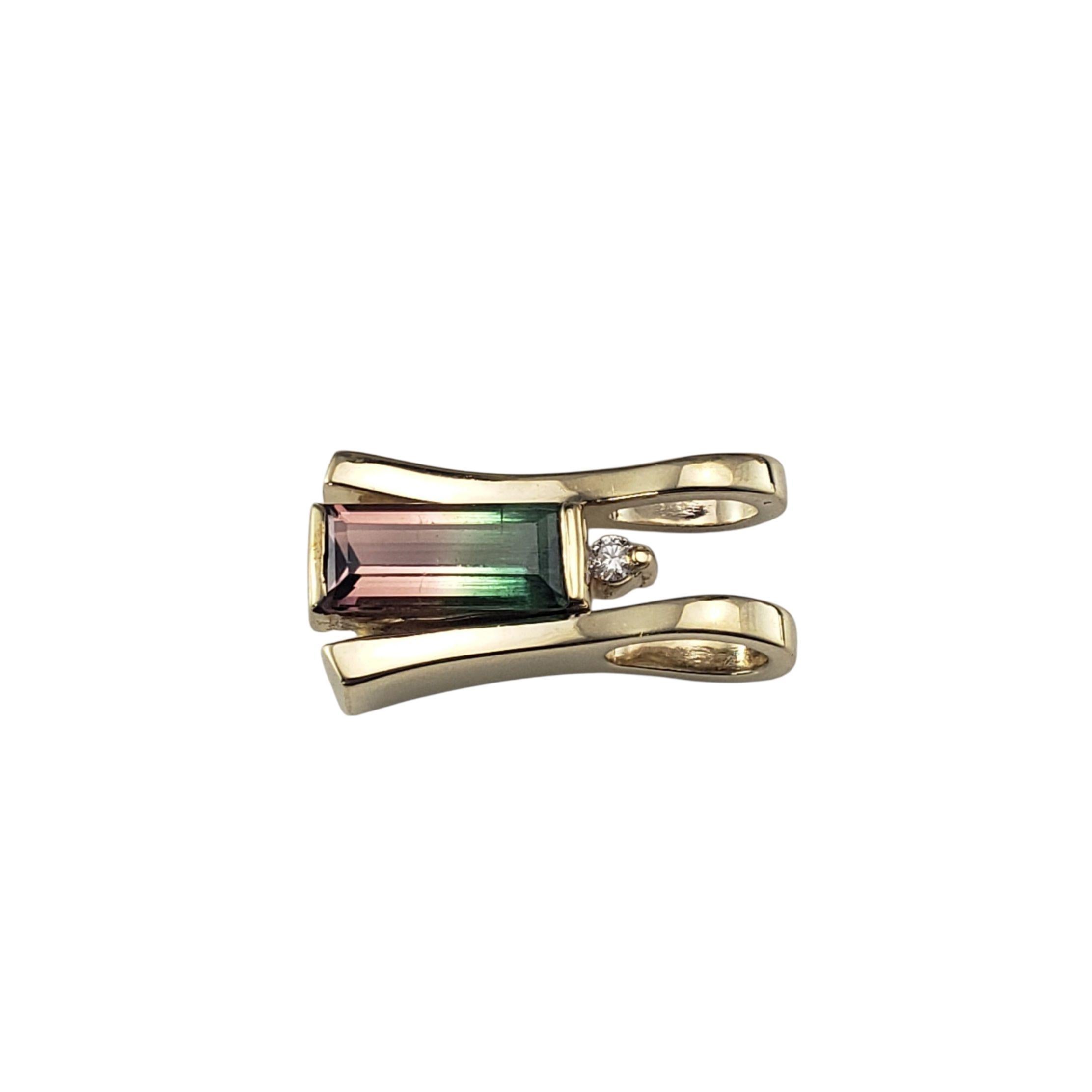 14K Yellow Gold Tourmaline and Diamond Pendant JAGi Certified-

This striking 14K yellow gold pendant showcases a vibrant bi-color baguette cut tourmaline with natural color that transitions from green to pinkish red. A single sparkling diamond
