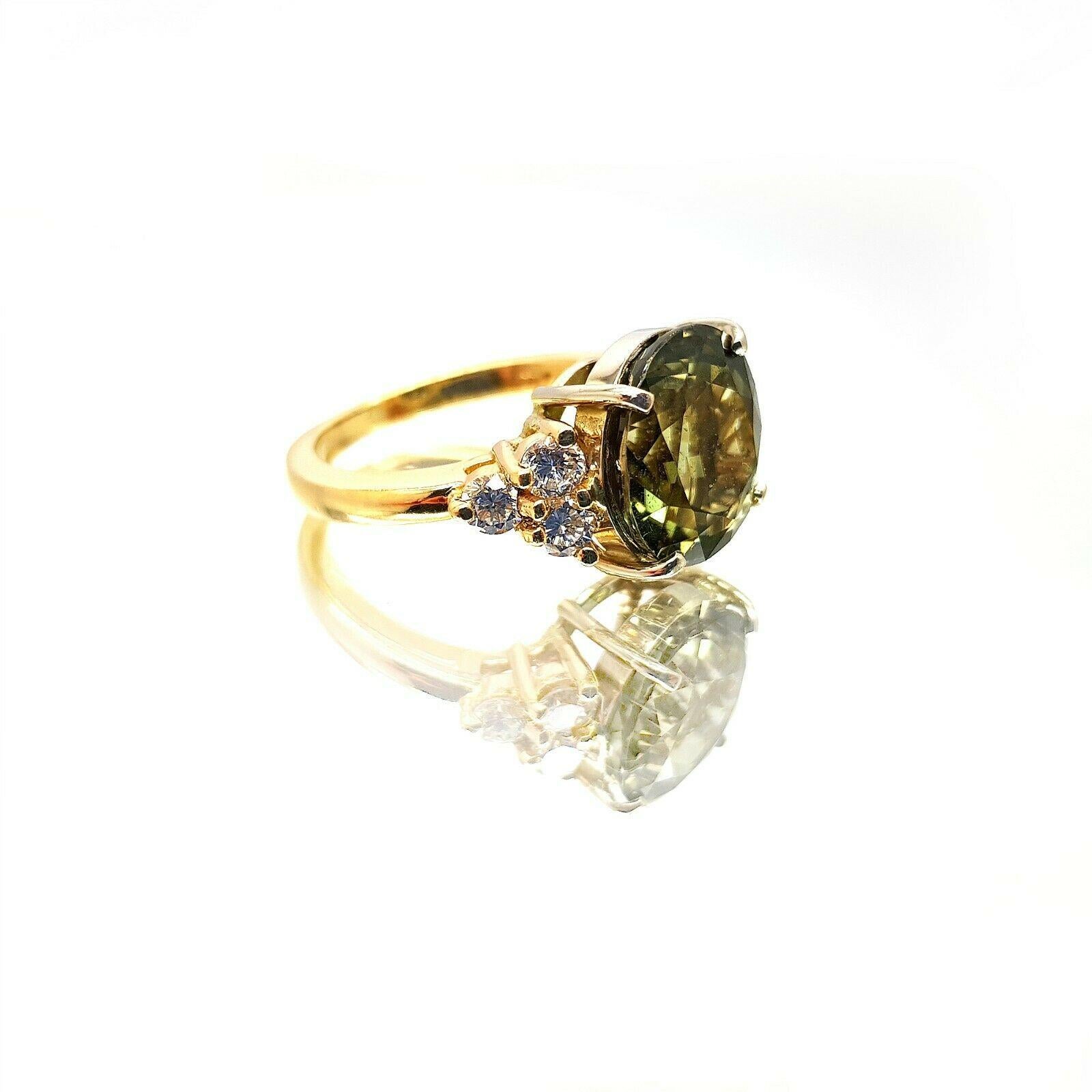  This is an 14k Yellow gold Tourmaline diamond ring. The main stone has the beautiful color of Green and is approximately 7.00 carat weight. It has a 6pcs round diamonds and has an approximately 0.60 carat total weight, H color and VS2 clarity. Its