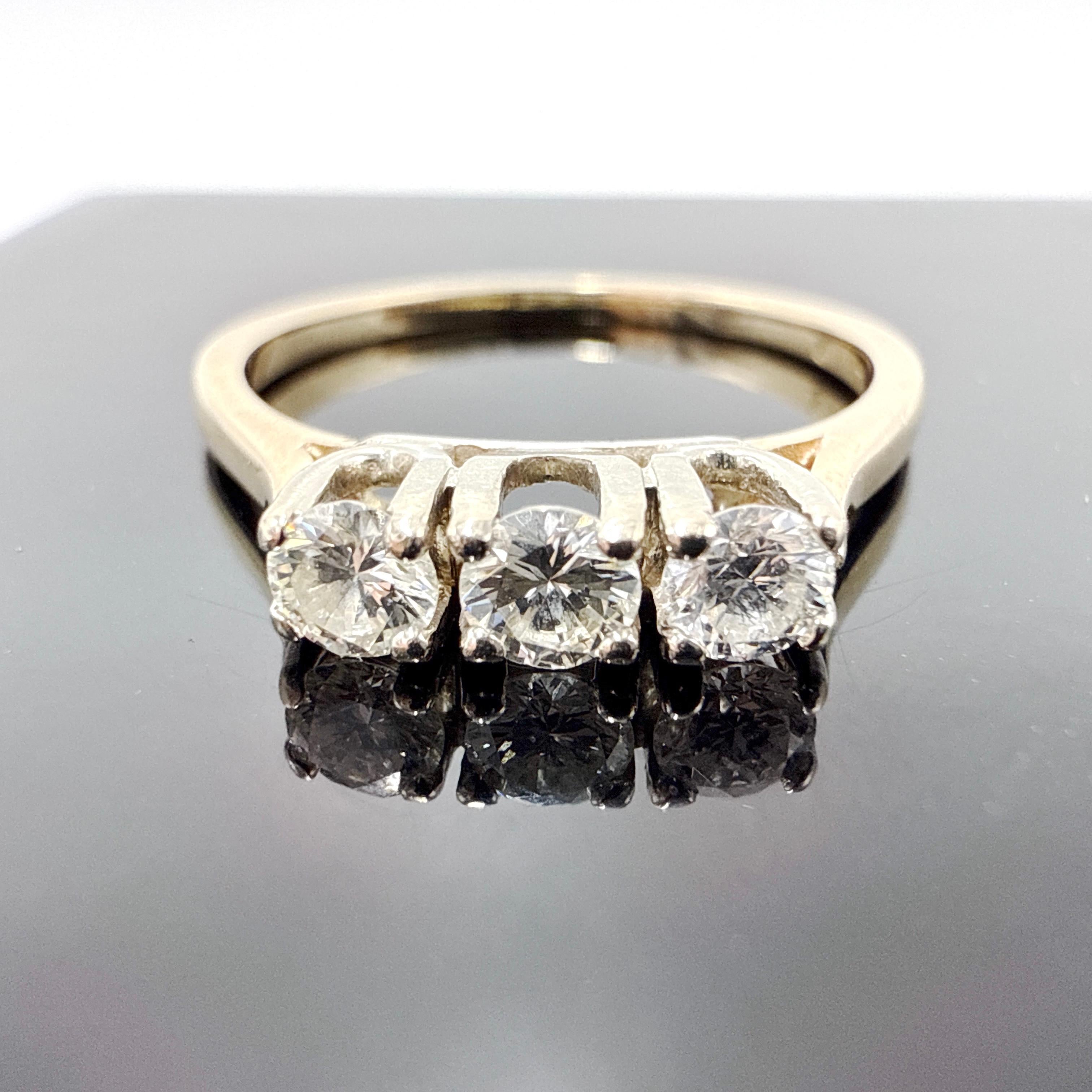 This classic trinity ring is crafted in solid 14K yellow gold with a wax cast, hand-assembled construction. The band features a tapered profile, measuring approximately 3.15 mm at the top and narrowing to 1.30 mm at the base. The shoulders are