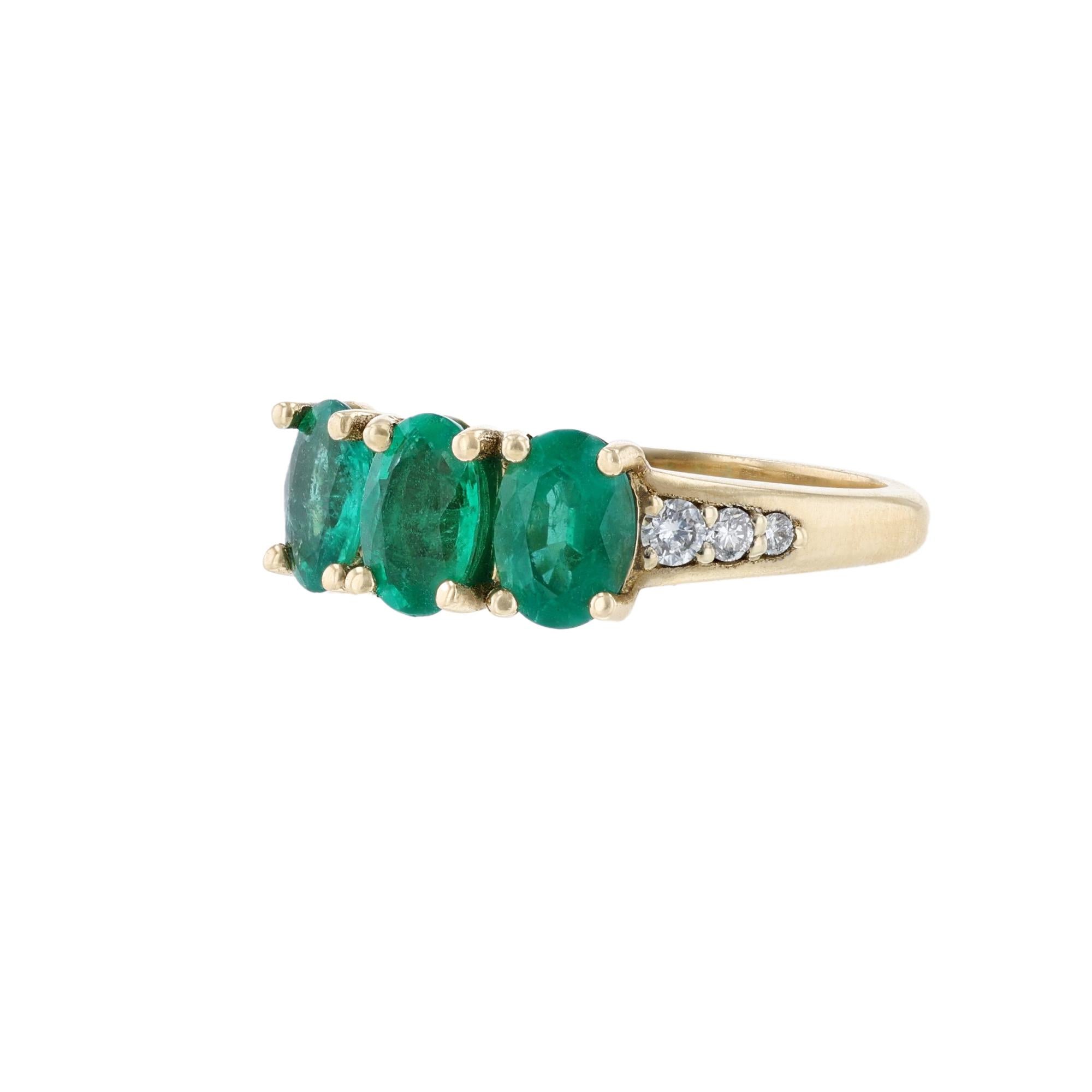 This ring is made in 14k yellow gold featuring 3 oval cut, prong set emeralds weighing 1.70 carats and 6 round cut diamonds weighing 0.16 carat. With a color grade (H) and clarity grade (SI2).