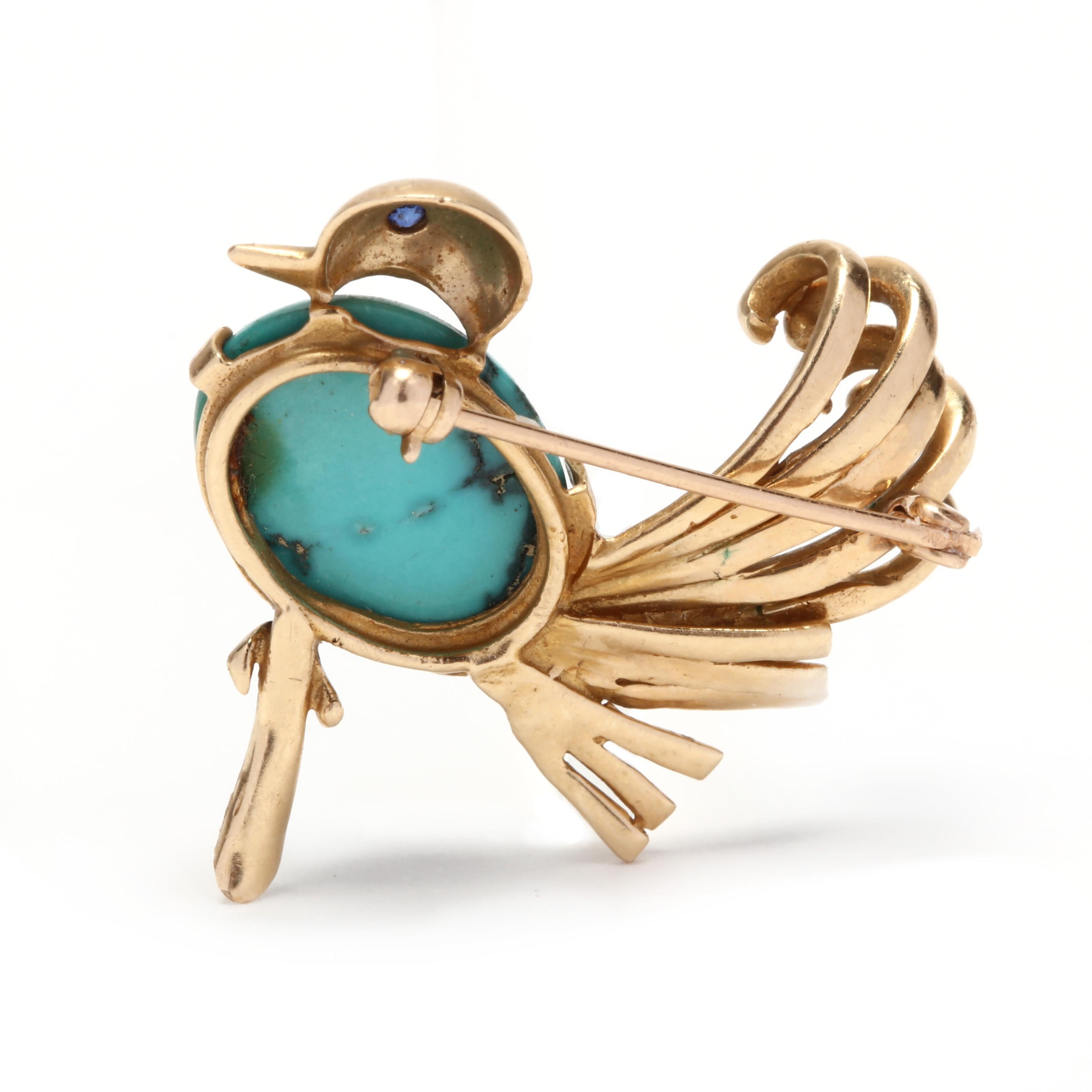 A 14 karat yellow gold and turquoise bird brooch. This brooch features a bird motif with an oval, cabochon turquoise body, a bezel set, round cut sapphire eye and a gold plume tail.

Stones:
- turquoise
- oval cabochon, 1 stone
- 16.2 x 12 mm

-