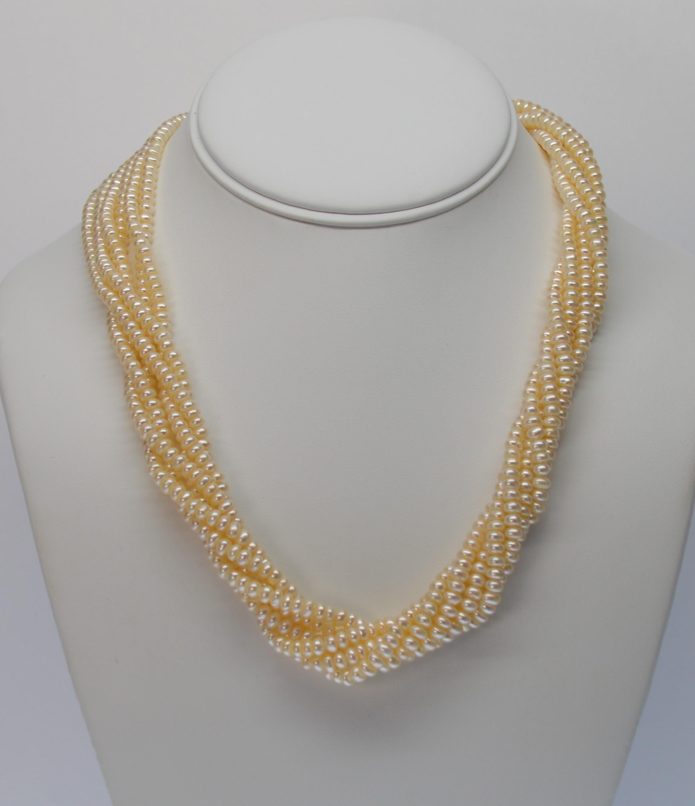 Bold 14K Yellow Gold Diamond Twin Lion Heads meet to make a powerful statement with this fine Akoya Pearl Six Strand Twist Style Necklace.
Eighteen inches of hand strung genuine Akoya Button Pearls measuring 4mm x 2.5mm tame these two big cats