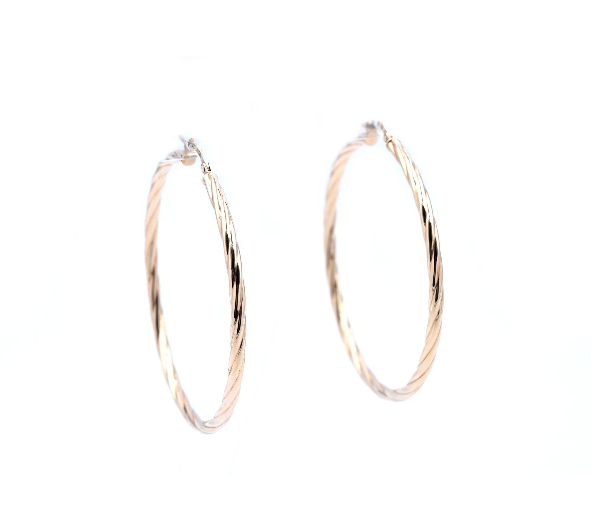 Material: 14k yellow gold
Dimensions: earrings measure 52mm in diameter  
Fastenings: snap closure
Weight: 3.29 grams
