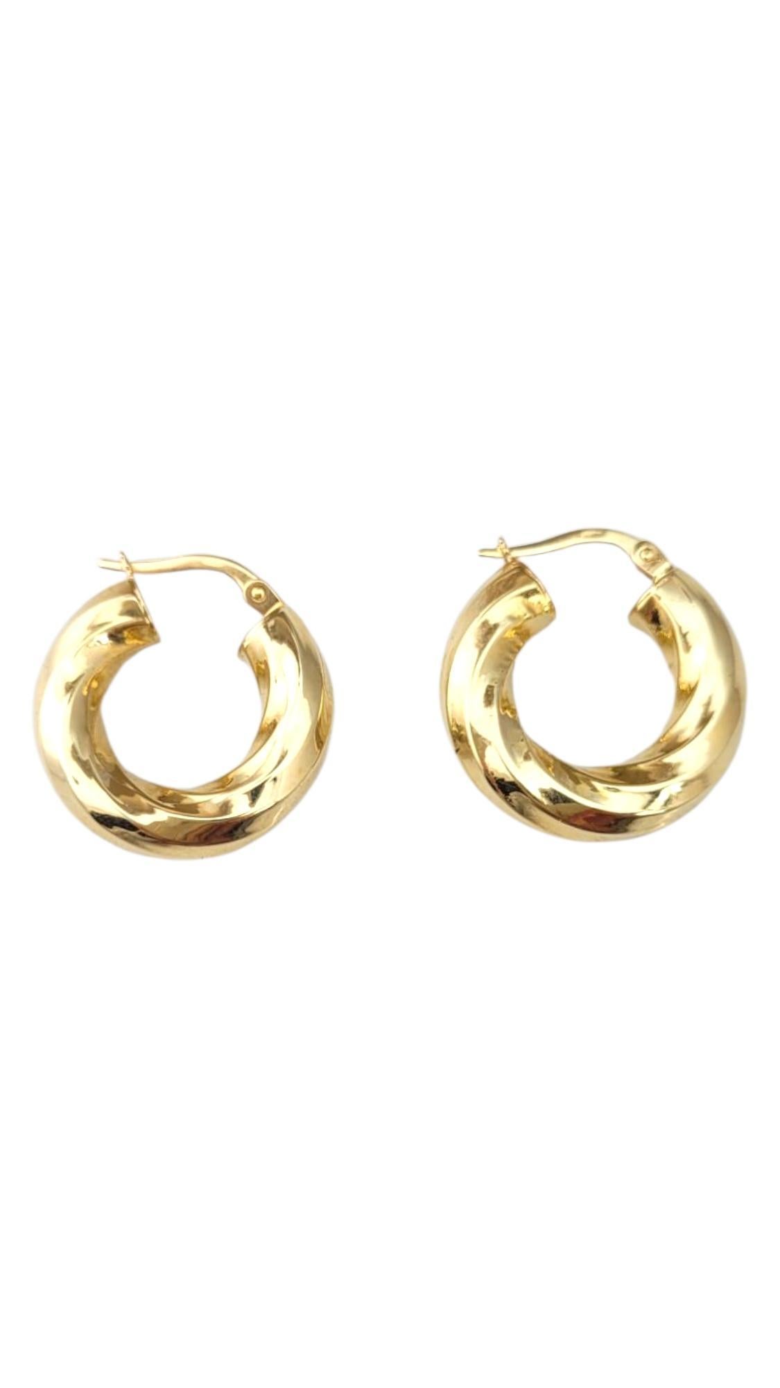 14K Yellow Gold Twisted Hoop Earrings 

These twisted hoop earrings feature an elegant spiral design that adds texture and movement to a classic silhouette. Stylish and eye-catching, they offer a modern twist on a timeless accessory—perfect for