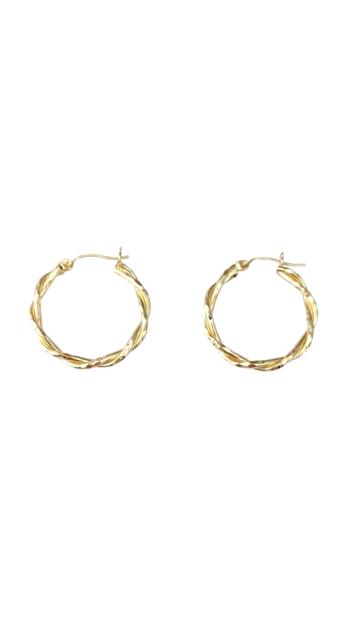 14K Yellow Gold Twisted Hoop Earrings -

These twisted hoop earrings feature an elegant spiral design that adds texture and movement to a classic silhouette. Crafted for both style and versatility, they catch the light beautifully—making them a