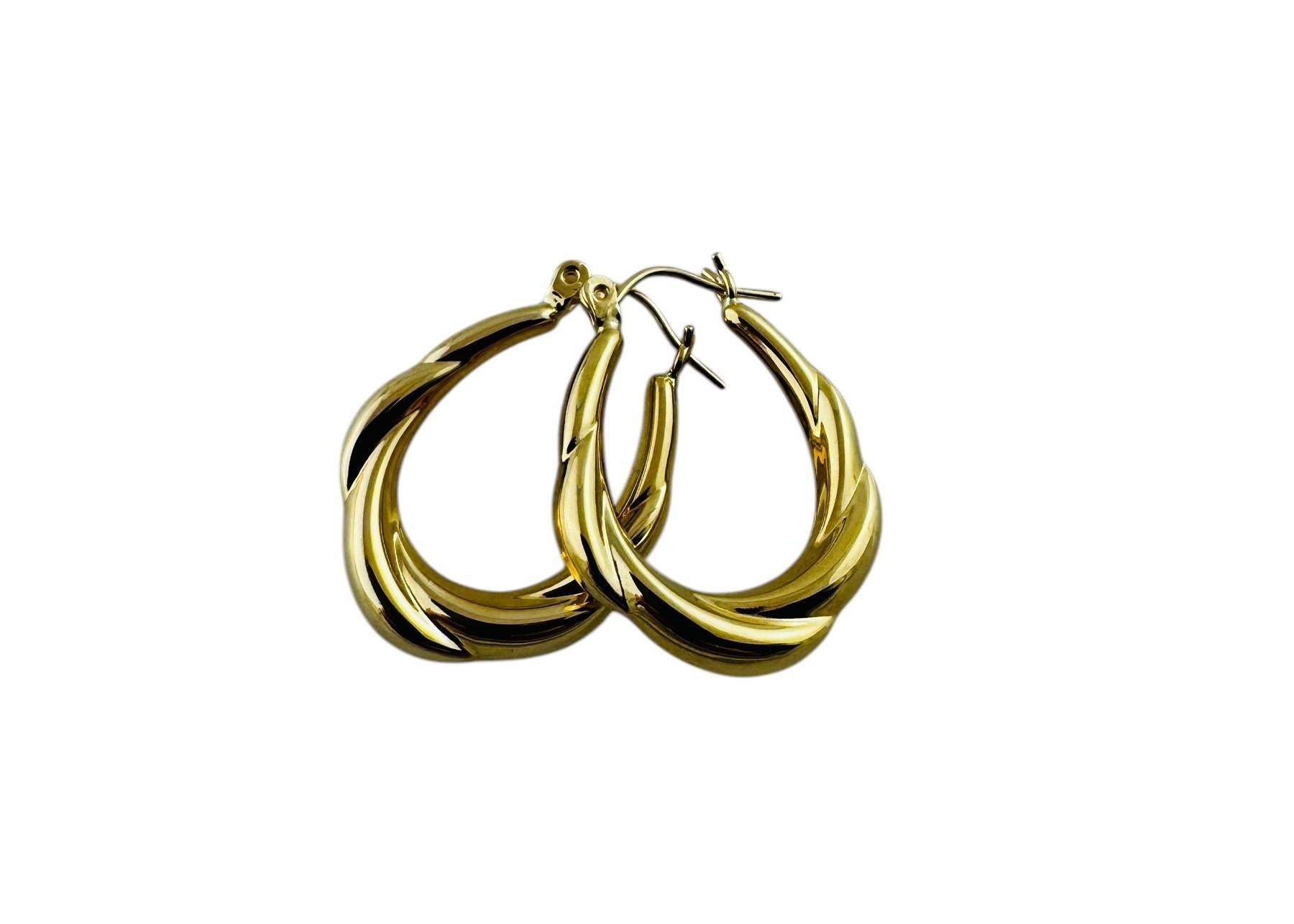 14K Yellow Gold Twisted Oval Hoop Earrings

These detailed oval hoop earrings are set in 14K yellow gold.

Stamped 14K

2.09 g / 1.34 dwt

Measurements: 25.5 mm in length, 19.4 mm wide, 4.5 mm thick

Very good preowned condition.

Will be shipped