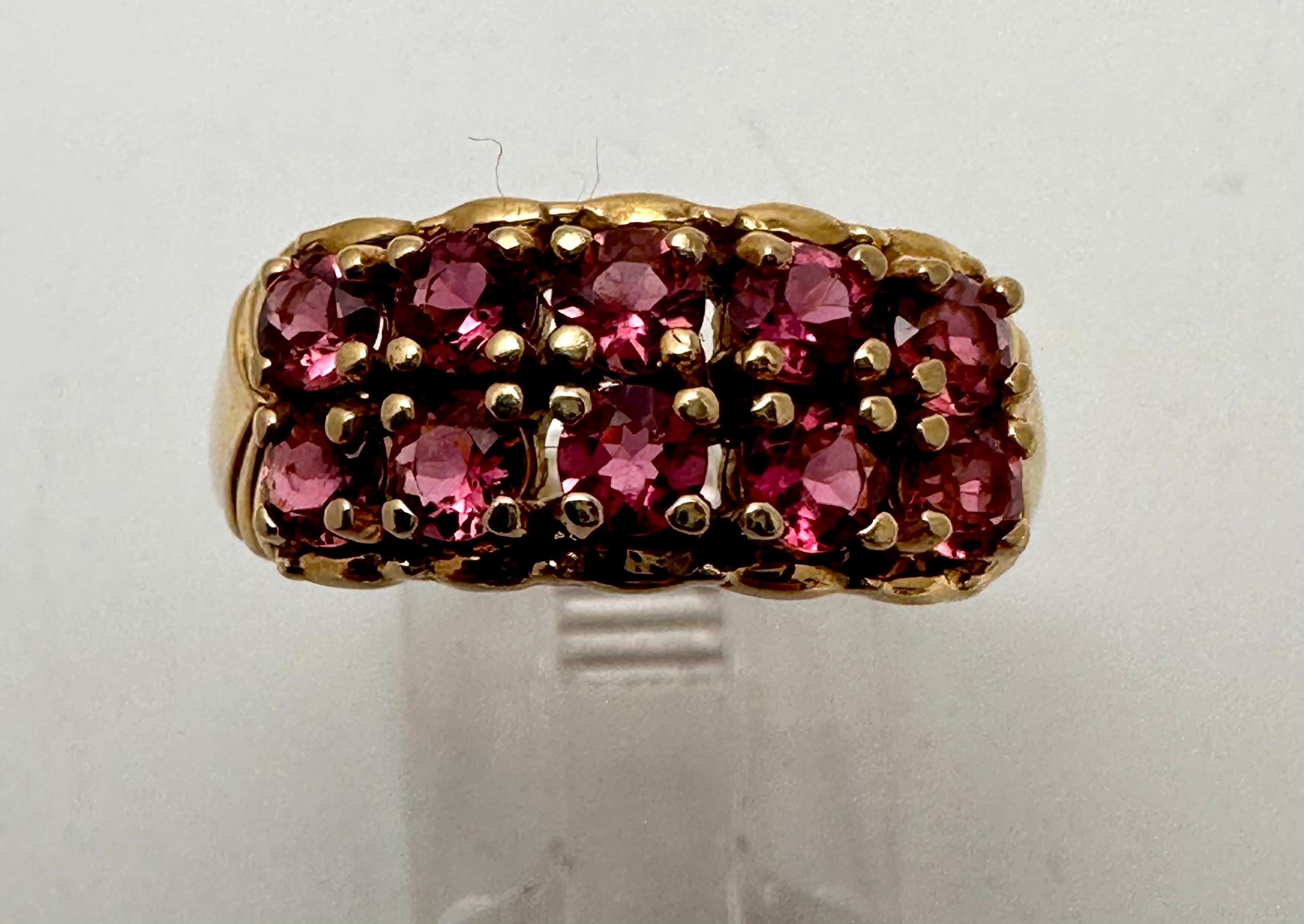 This stunning 14k yellow gold ring boasts two rows of 5 stones each, (ten total) natural round-shaped rubies approx 3mm. The ring is a size 7.25 and can be further adjusted to fit with its sizeable option. The prong setting style enhances the beauty