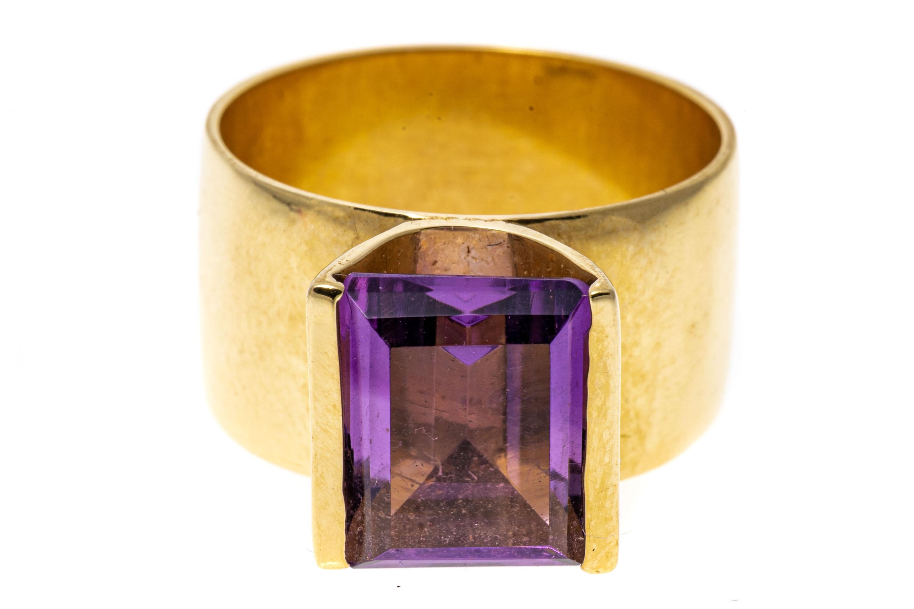 14k yellow gold ring. This contemporary ring has a rectangular faceted, light purple color amethyst, approximately 2.50 CTS, framed by half bezels and a 