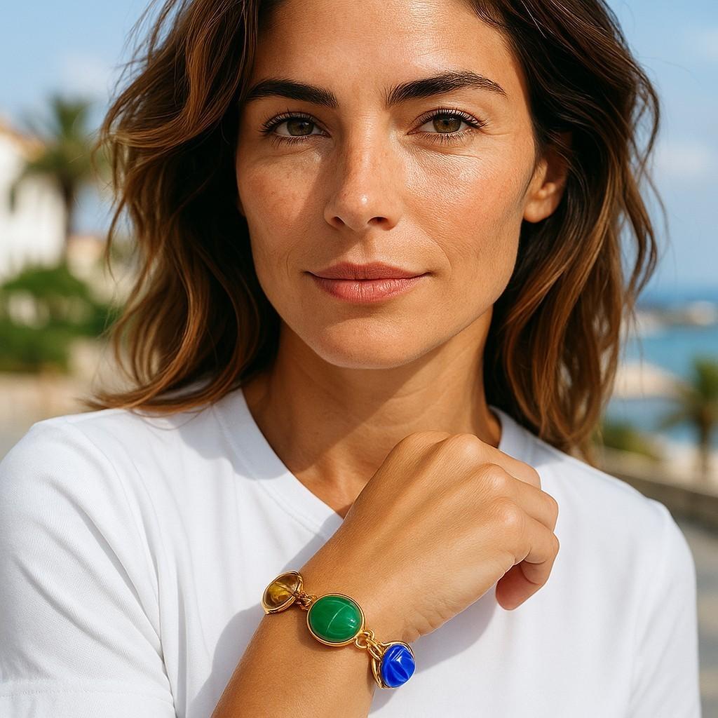 A Timeless Celebration of Color and Heritage
Elevate your jewelry collection with this 14K Yellow Gold Multi-Hardstone Scarab Bracelet, a classic design that showcases vibrant gemstones carved into the iconic scarab shape. Each stone’s unique color