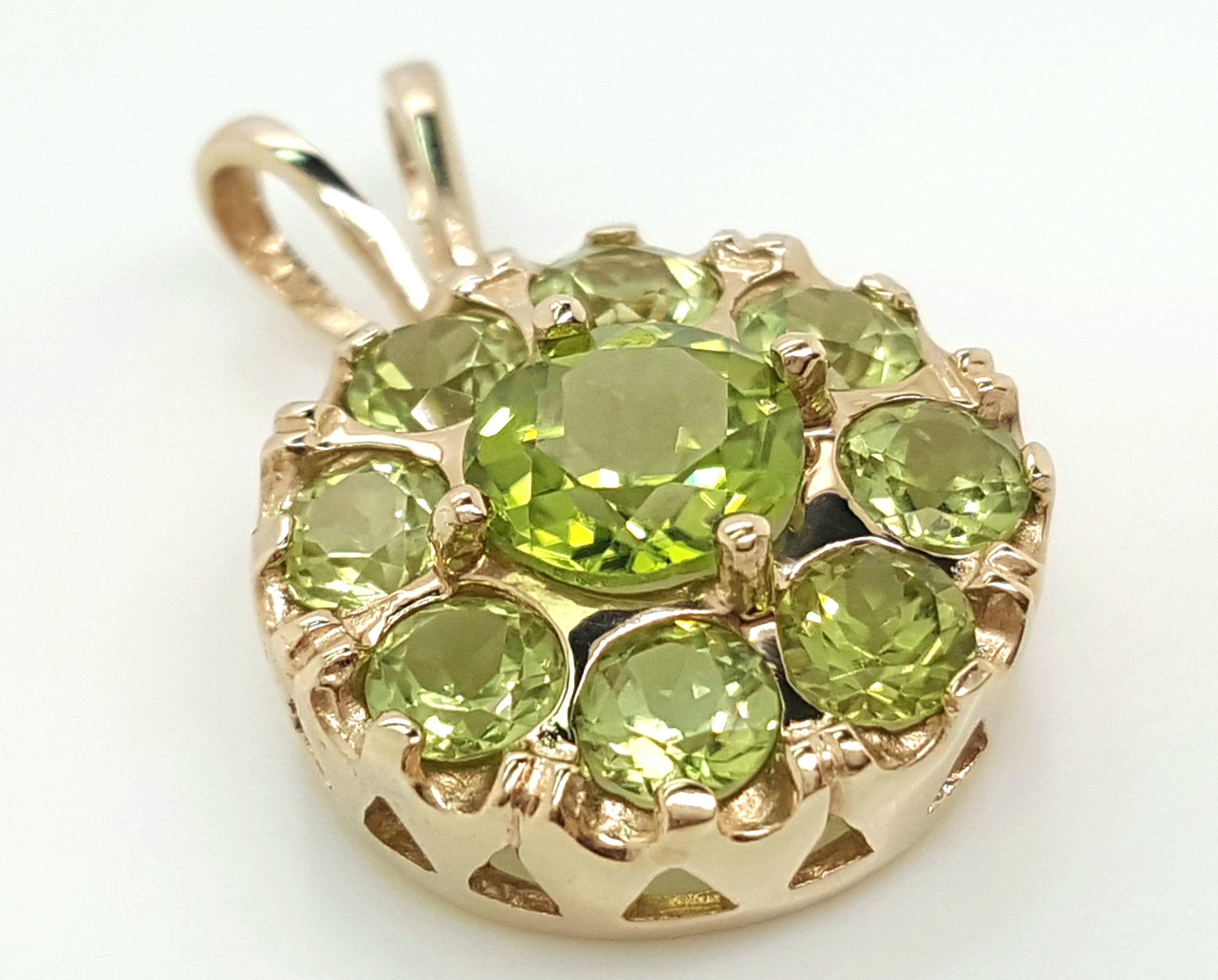 14 Karat Yellow Gold Victoria Style Peridot Pendant   The feminine pendant style dates back to the 1840's and features a round peridot set in four prongs and elegantly surrounded by a halo of round peridots, accented by a rabbit ear bail.  Weighing