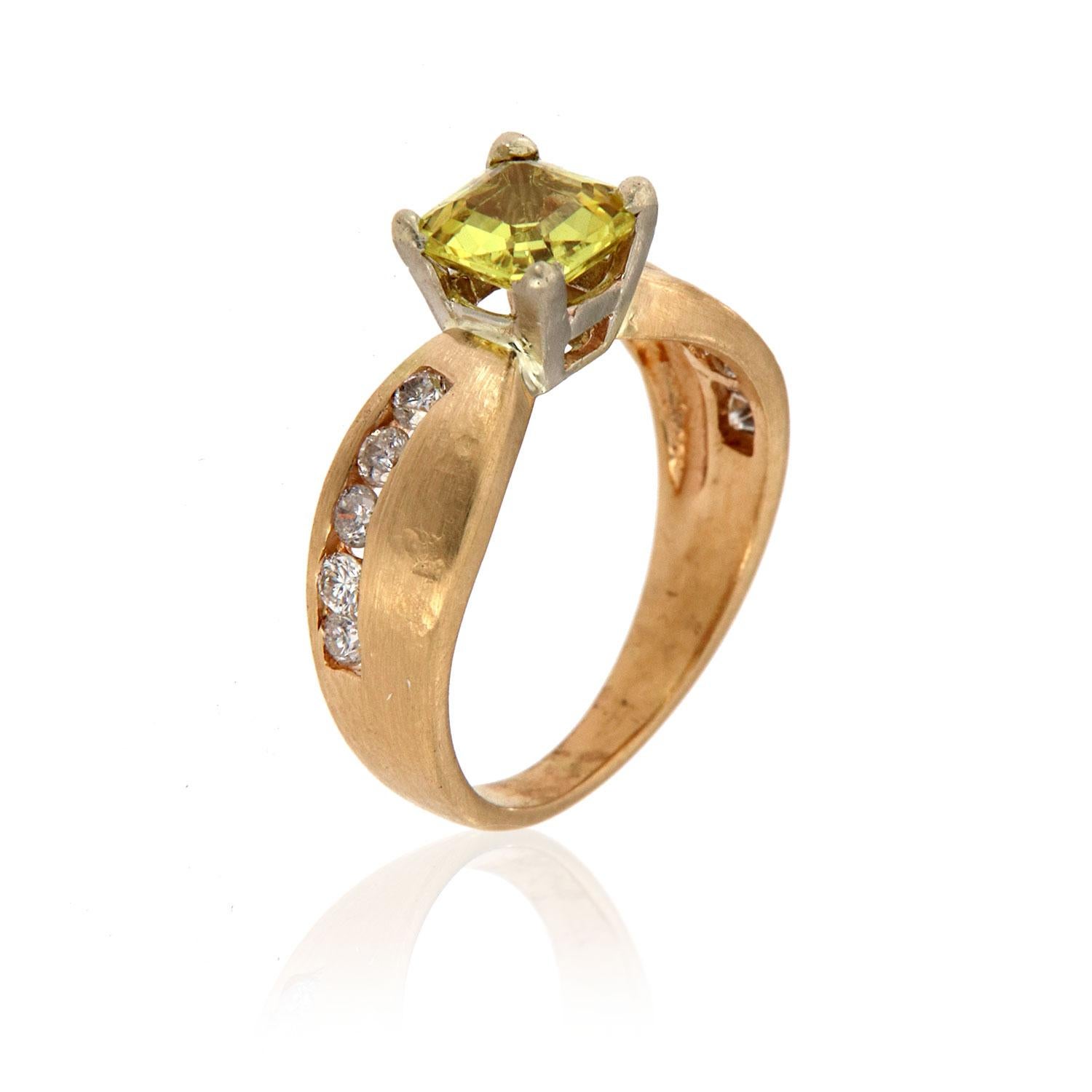 This ring features an Asscher shaped 1.15-Carat natural unheated Sri-Lankan Yellow Sapphire four (4) prong - set. A wavey row of round brilliant diamonds channel set from each side of the center gem. The slightly hammered and matte-finished bringing