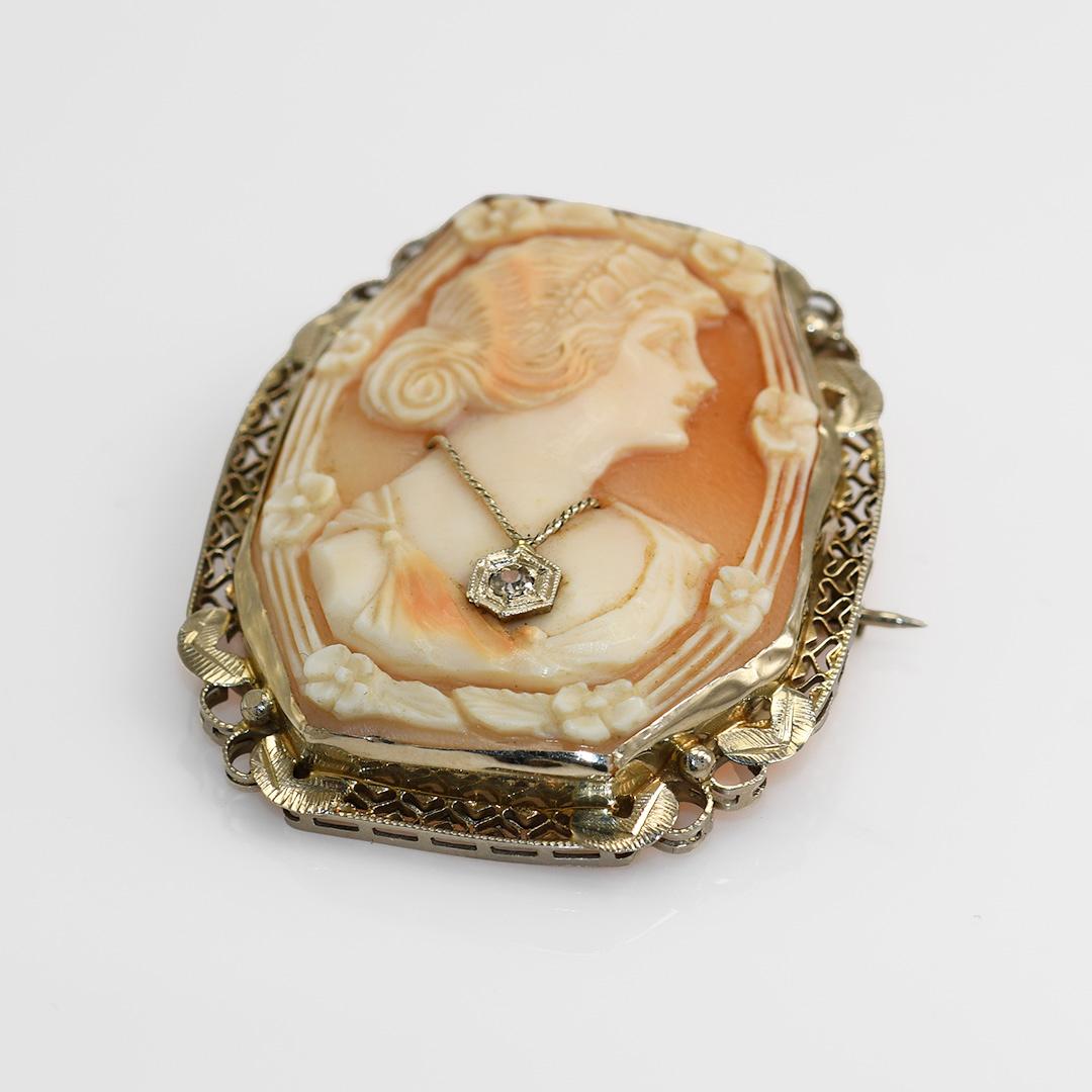 Vintage shell cameo with 14k yellow gold frame.

The hinge on the clasp is stamped 14k.

Gross weight is 9 grams.

Hand carved conk shell cameo.

Very good details.

The gold frame has attractive filligree work.

The cameo measures 1 1/2 by 1 1/4