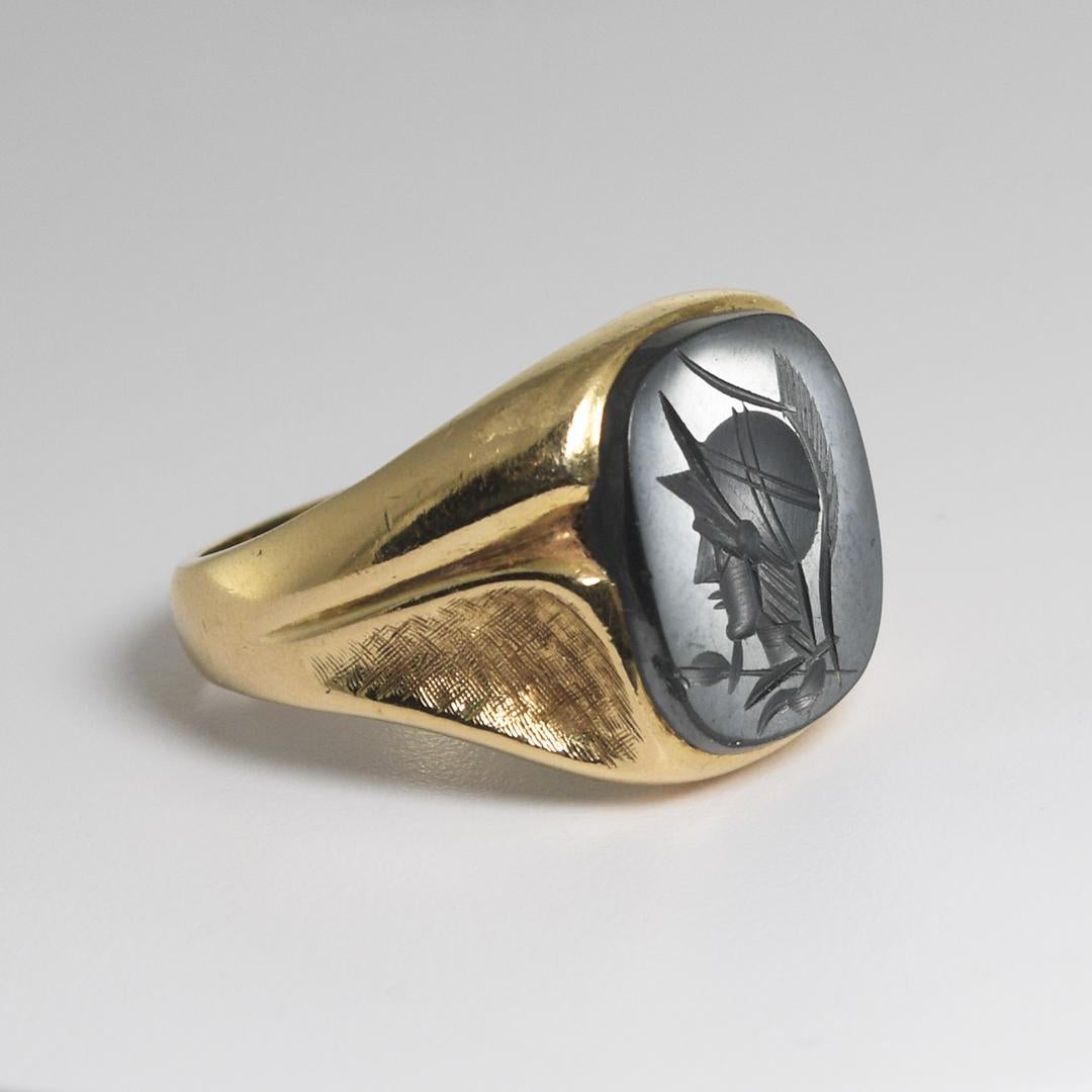 Men's vintage 14k yellow gold and hematite ring.
Stamped 14k and weighs 13.4 grams gross weight.
The gold tests 56.5% gold using an XRF metals analyzer.
The hematite stone is engraved with the head of a Roman soldier.
The top of the ring measures