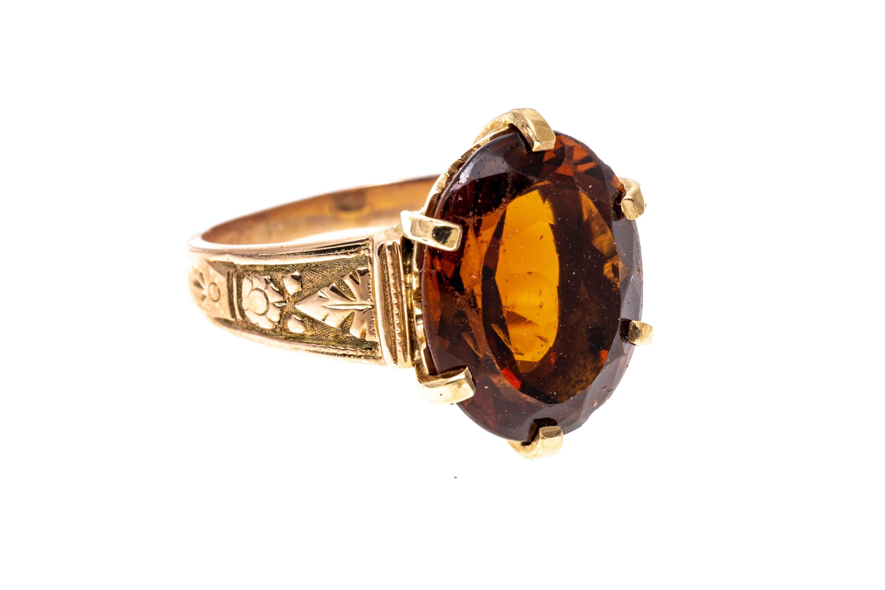 10k yellow gold ring. This pretty vintage ring features a center oval faceted, dark orange color citrine, approximately 4.93 CTS, accented by flower and foliate decorated shoulders.
Marks: None, tests 10k
Dimensions: 3/8