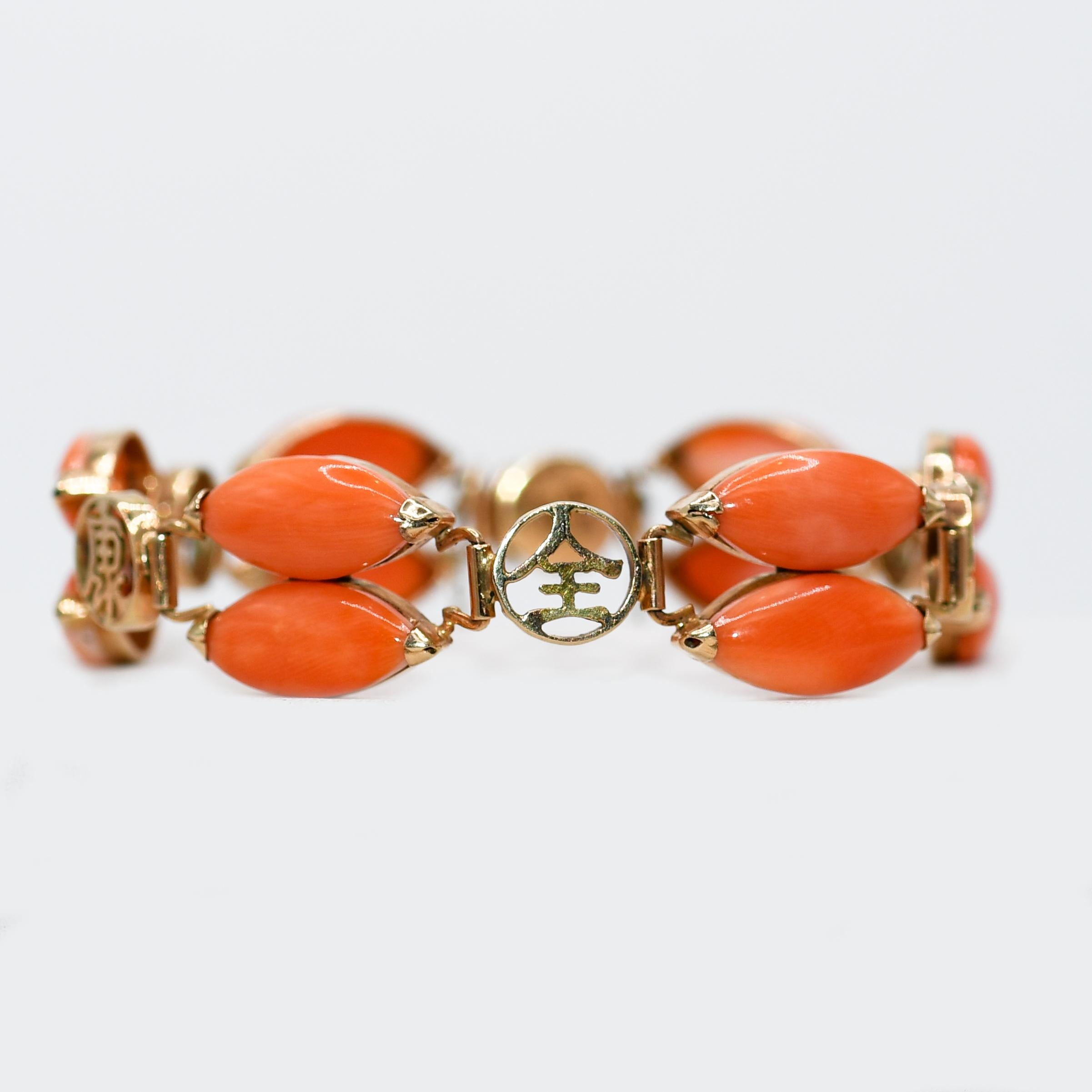 Ladies vintage 14k yellow gold and pink coral bracelet.
Stamped 14k and weighs 16 grams gross weight.
Approximately 10 grams of 14k gold.
The coral is a pinkish-orange color, marquise shaped stones set in a heavy duty gold setting.
The bracelet