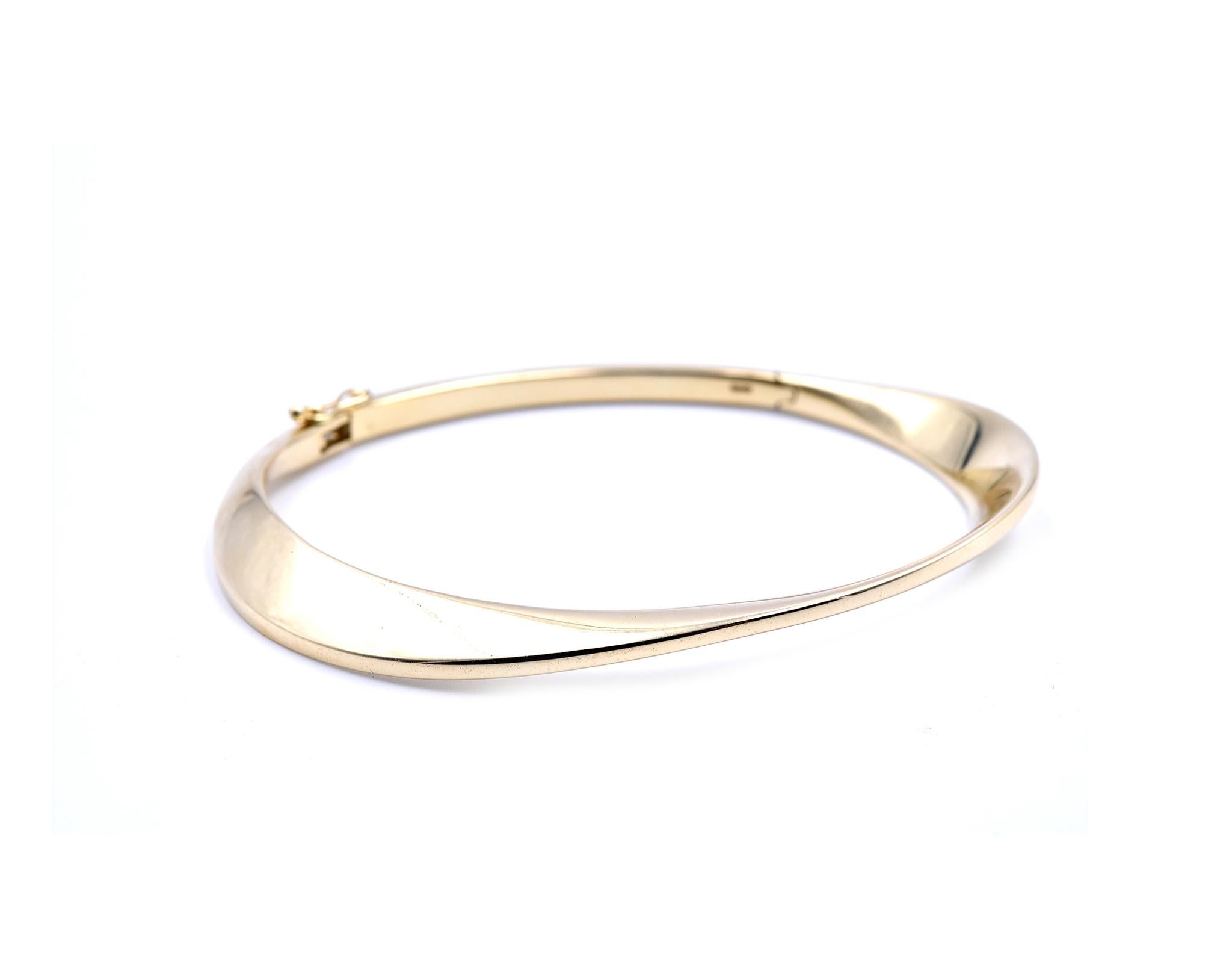 Designer: custom
Material: 14k yellow gold
Dimensions: bangle will fit 7” inch wrist and it is 7.56-8.24mm wide
Weight: 25.90 grams
