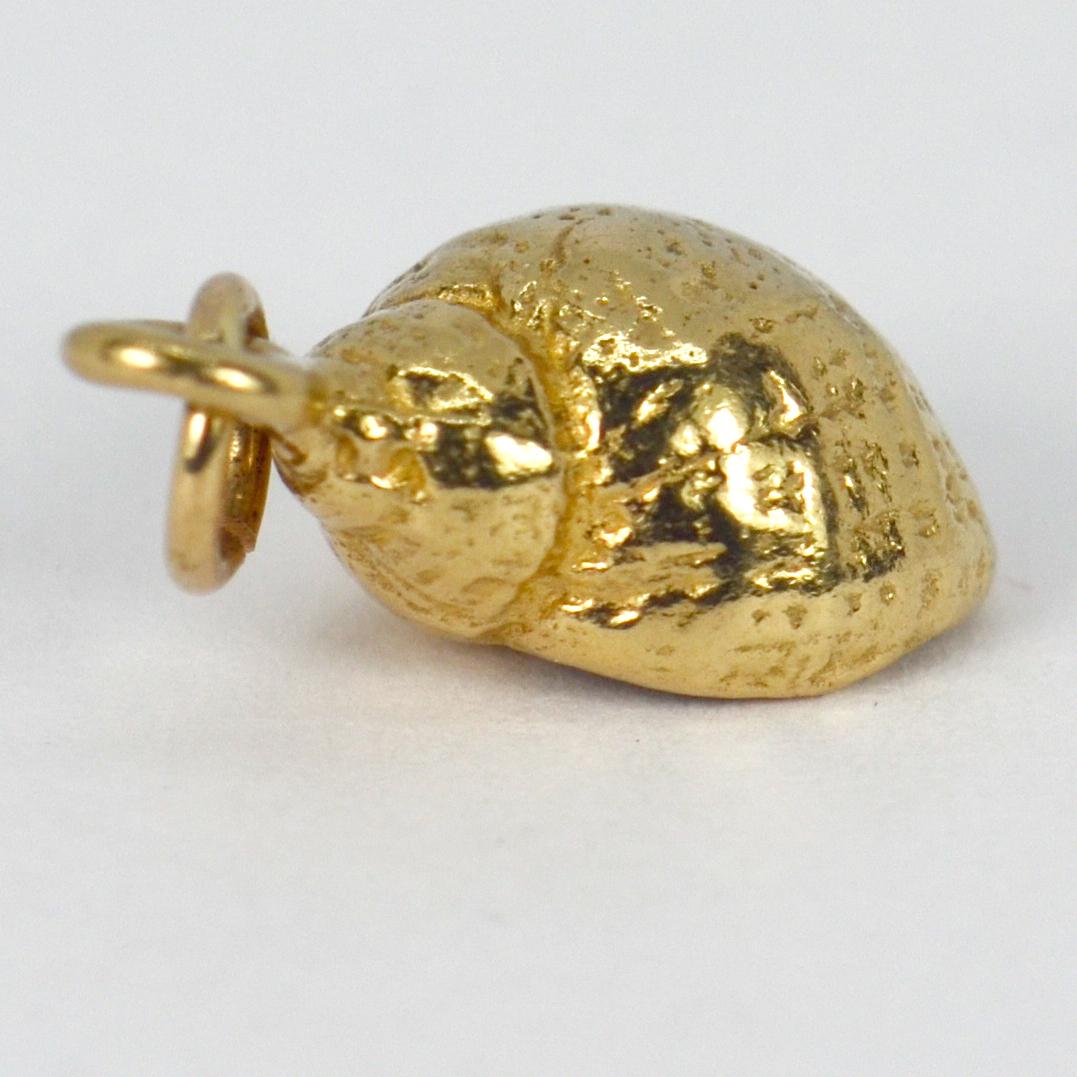 A 14 karat (14K) yellow gold charm pendant designed as a whelk shell. Stamped 14K for 14 karat gold and American manufacture.

Dimensions: 2.2 x 1 x 0.8 cm
Weight: 4.88 grams
