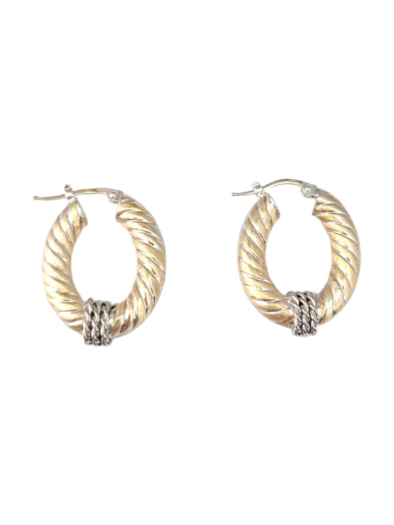 14K Yellow Gold & White Gold Two Tone Oval Cable Hoop Earrings -

These 14K yellow and white gold two-tone oval hoop earrings blend classic elegance with modern style. The sleek oval shape offers a refined twist on traditional hoops, while the