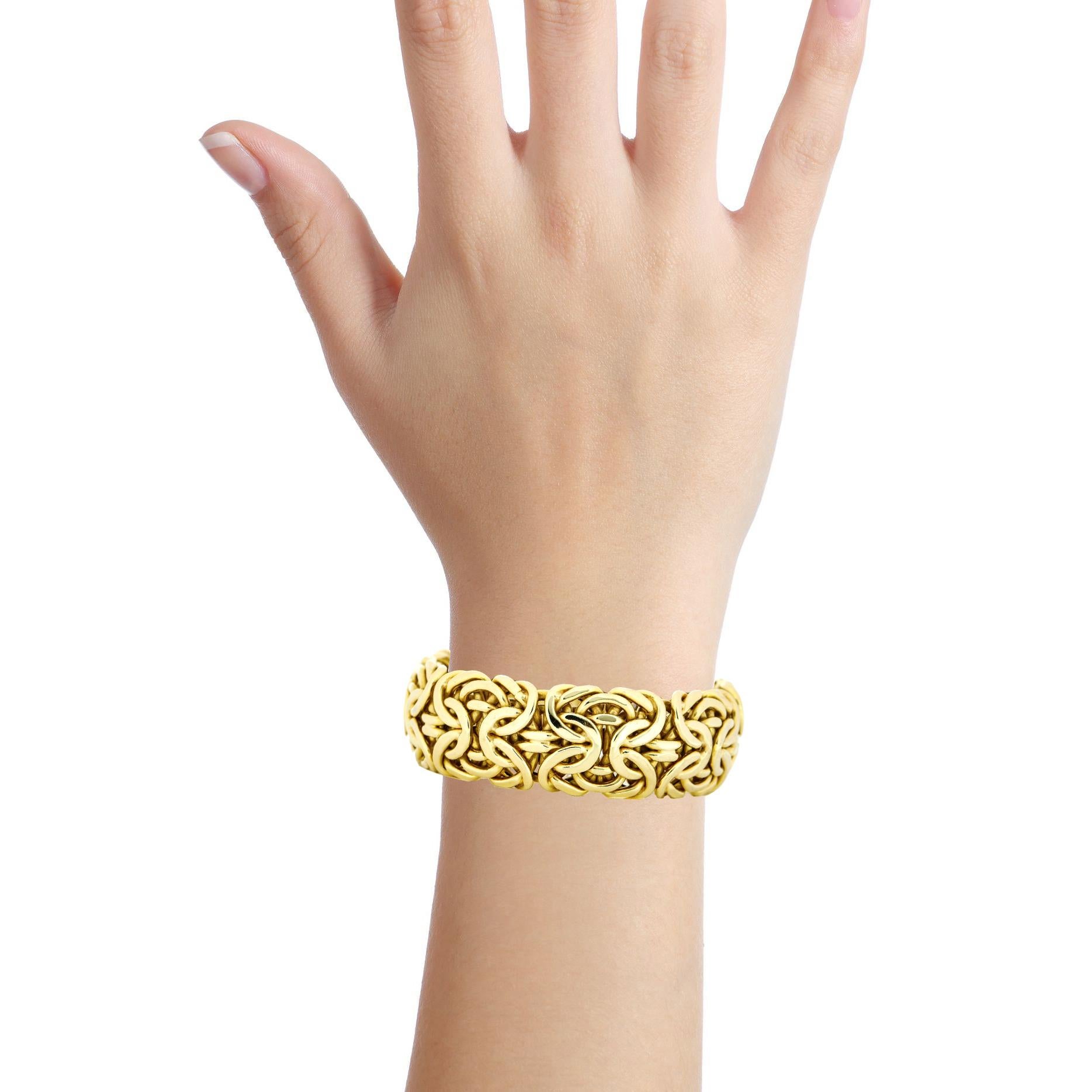 Wide byzantine bracelet in 14-karat yellow gold. Slide clasp. Signed fancy. 

Size, Medium
Length, 8 inches 
Width, 22mm 
Depth, 7mm
Weight, 62.4 grams 

Previously owned, in very good condition with some small dents. Original packaging not
