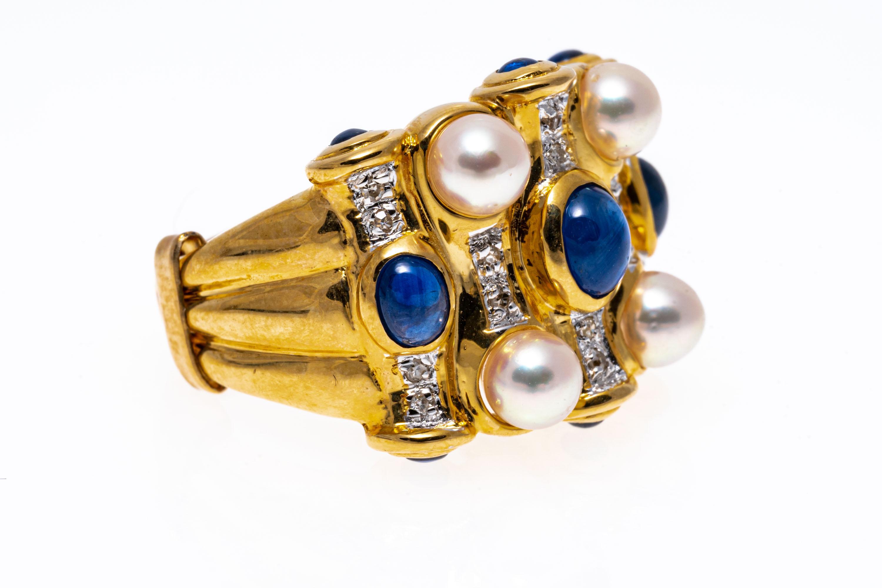 14k yellow gold ring. This stunning dome ring contains four, 4.25 mm pink toned, high lustre cultured pearls, set among a field of round faceted diamonds, approximately 0.08 TCW and punctuated with round and oval cabachon cut blue sapphires,