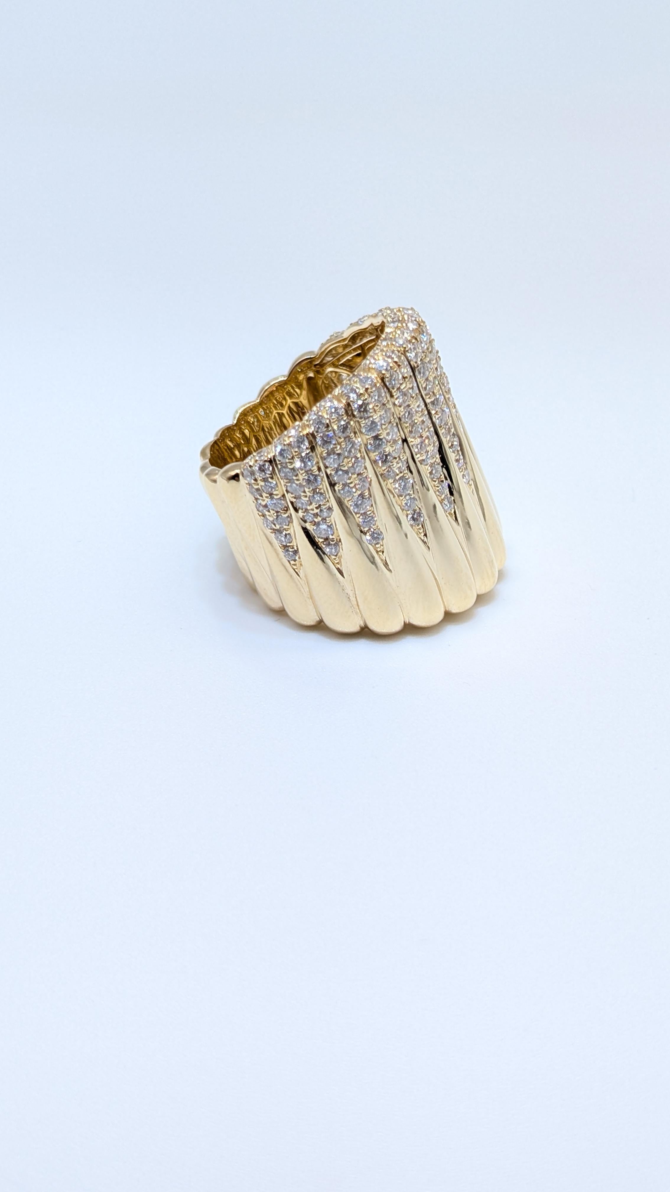 This stunning 14-karat yellow gold wide fashion ring features a bold and luxurious design, adorned with diamonds totaling 2.10 carats. The diamonds are set in a brilliant pave setting, which enhances their sparkle and creates a continuous,