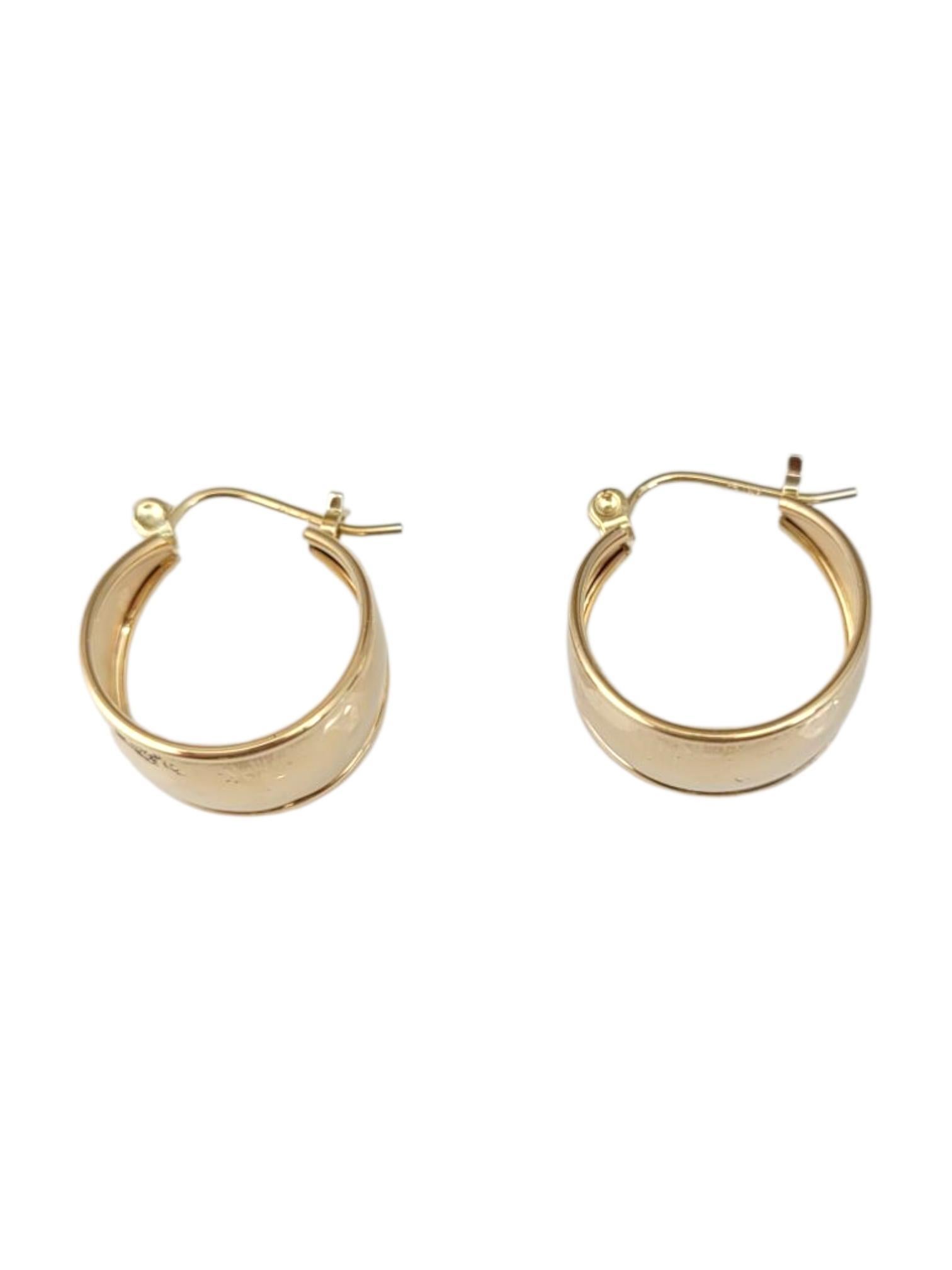 14K Yellow Gold Wide Hoop Earrings -

These hoop earrings feature a simple yet elegant design, perfect for adding a timeless touch to any look. Crafted for versatility, they effortlessly complement both casual and formal styles, making them an