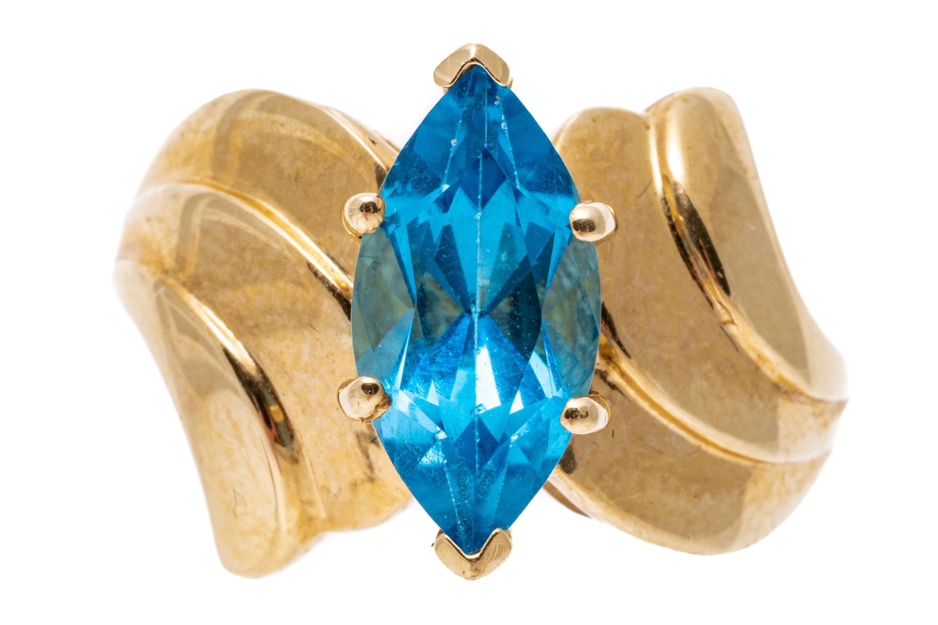 Women's 14k Yellow Gold Wide Ribbed Bypass Style Marquise Blue Topaz Ring For Sale