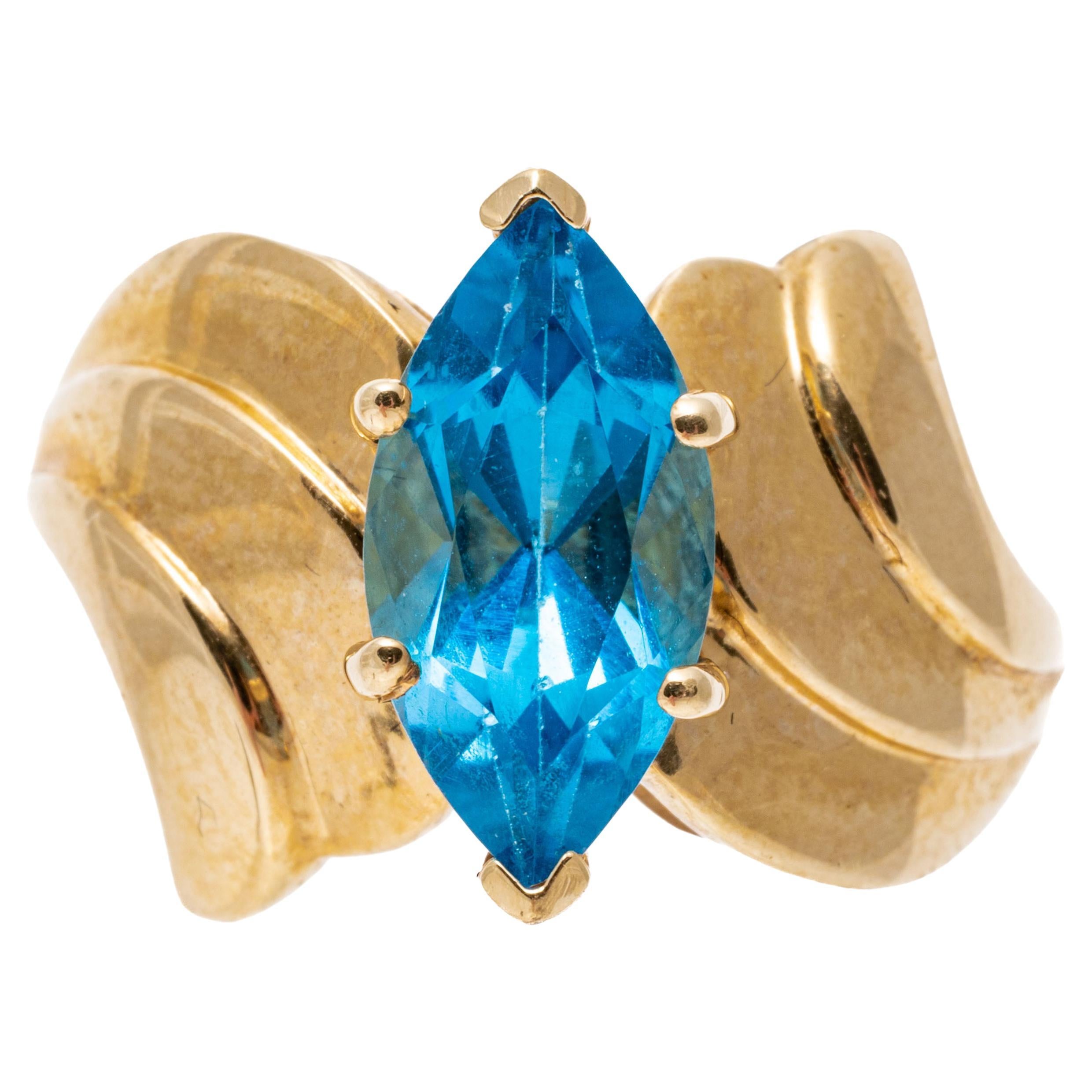 14k Yellow Gold Wide Ribbed Bypass Style Marquise Blue Topaz Ring For Sale