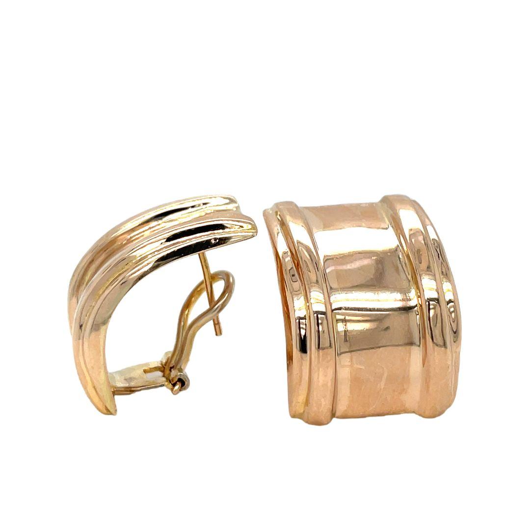Gorgeously designed to express your sophisticated style, these classic J hoop earrings are created in 14K yellow gold. Measuring 17.3mm wide and 23.23mm long, they are finished to give out a shiny aura and are equipped with posts and  omega closures