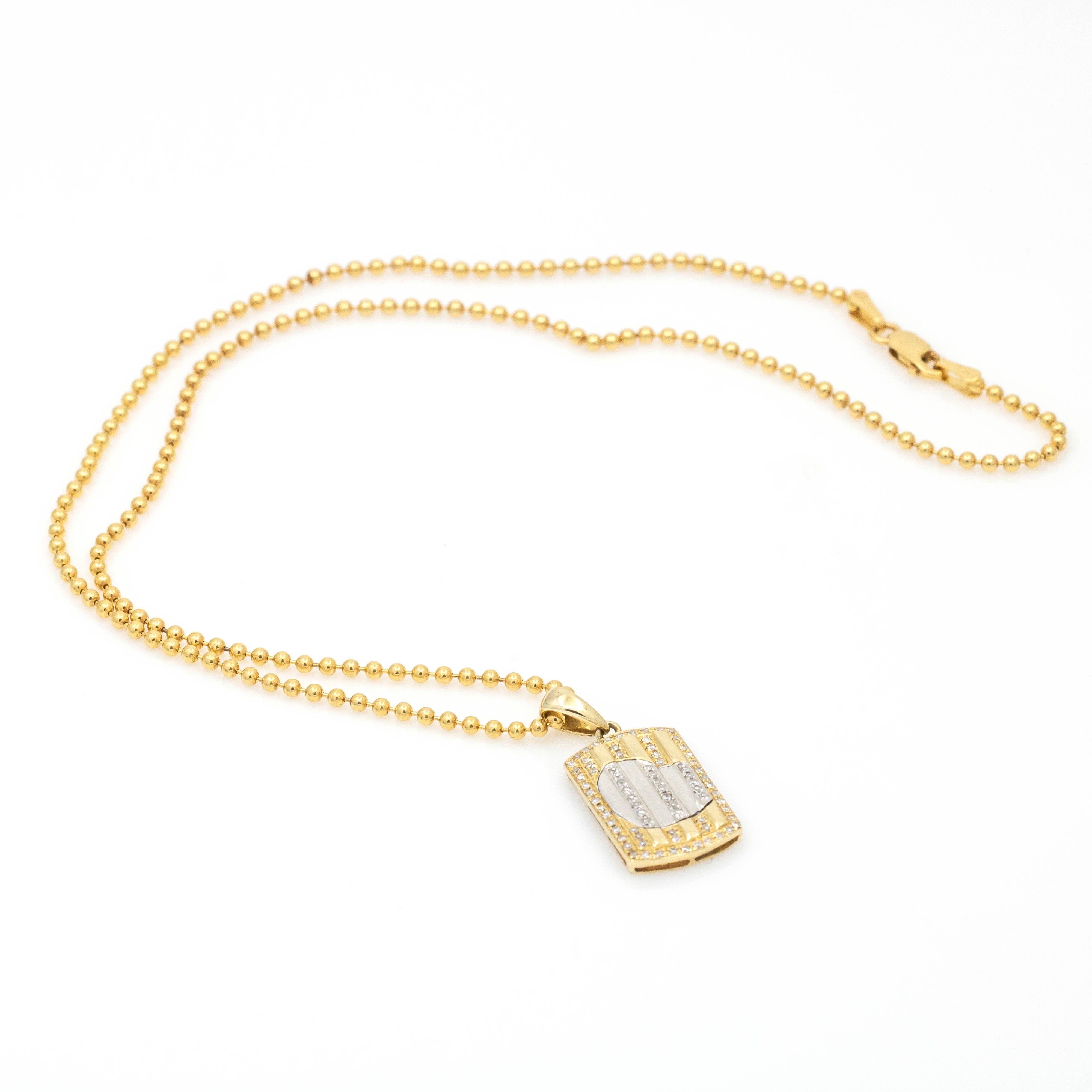 This Women's Diamond Heart Mini Dog Tag Pendant Necklace is a cute and feminine accessory perfect for layering. Crafted in 14k yellow gold with white gold heart detail and pave diamond accents, it's a unique twist on the classic dog tag design. The