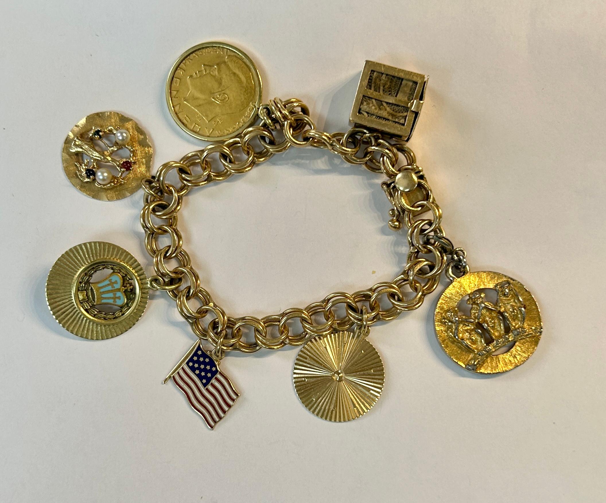Women’s 14K yellow gold vintage charm bracelet with seven charms. One charm has small pearl, ruby, and sapphire stones. Other charms include gold Kennedy coin, a money bundle, a group of monkeys (see no, hear no, speaks no-evil). Very unique and a