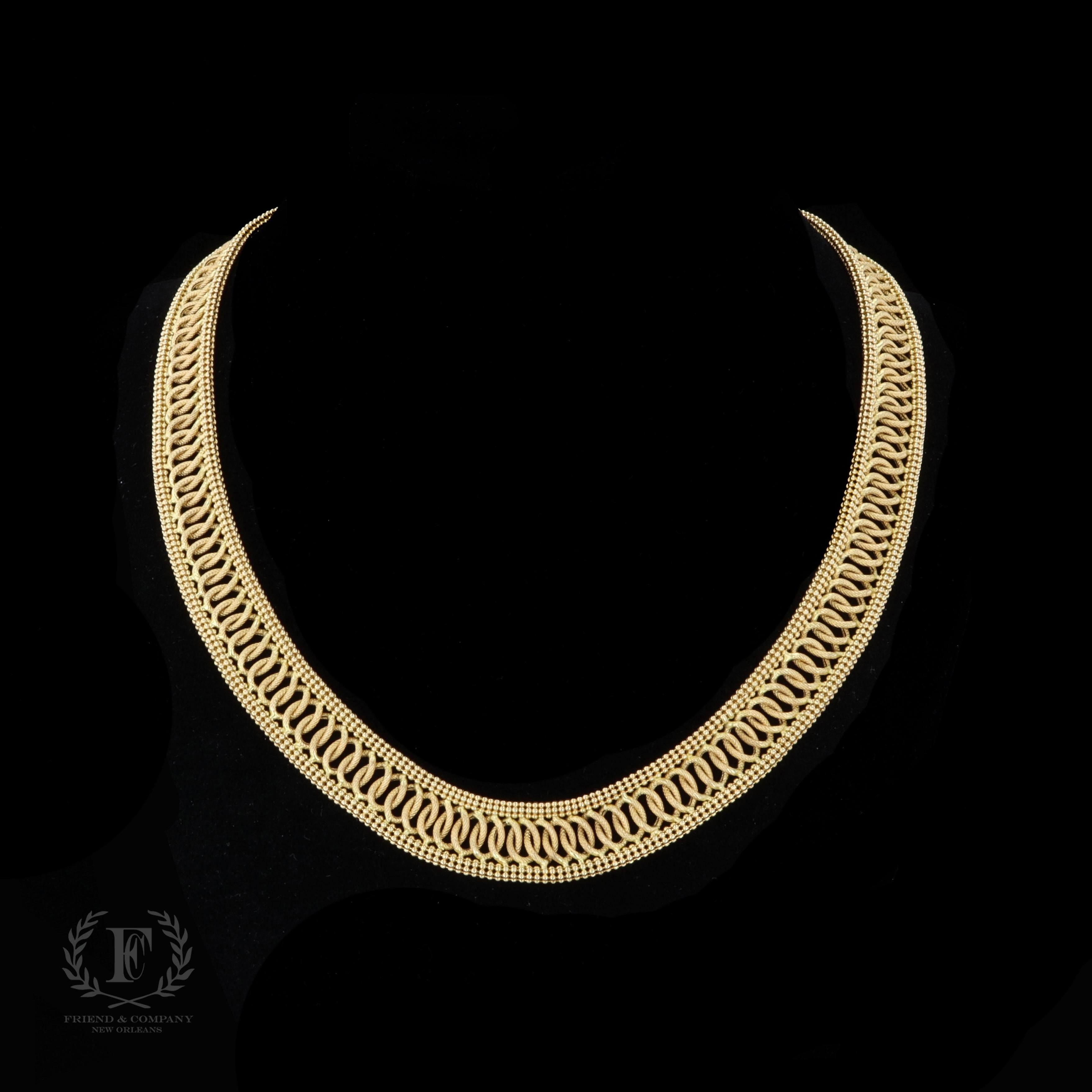 Beautiful woven layers of 14 karat yellow gold to create this spectacular necklace. It features a 14k yellow gold clasp as well as four cabochon cut blue sapphires. The necklace measures 17 inches in length.