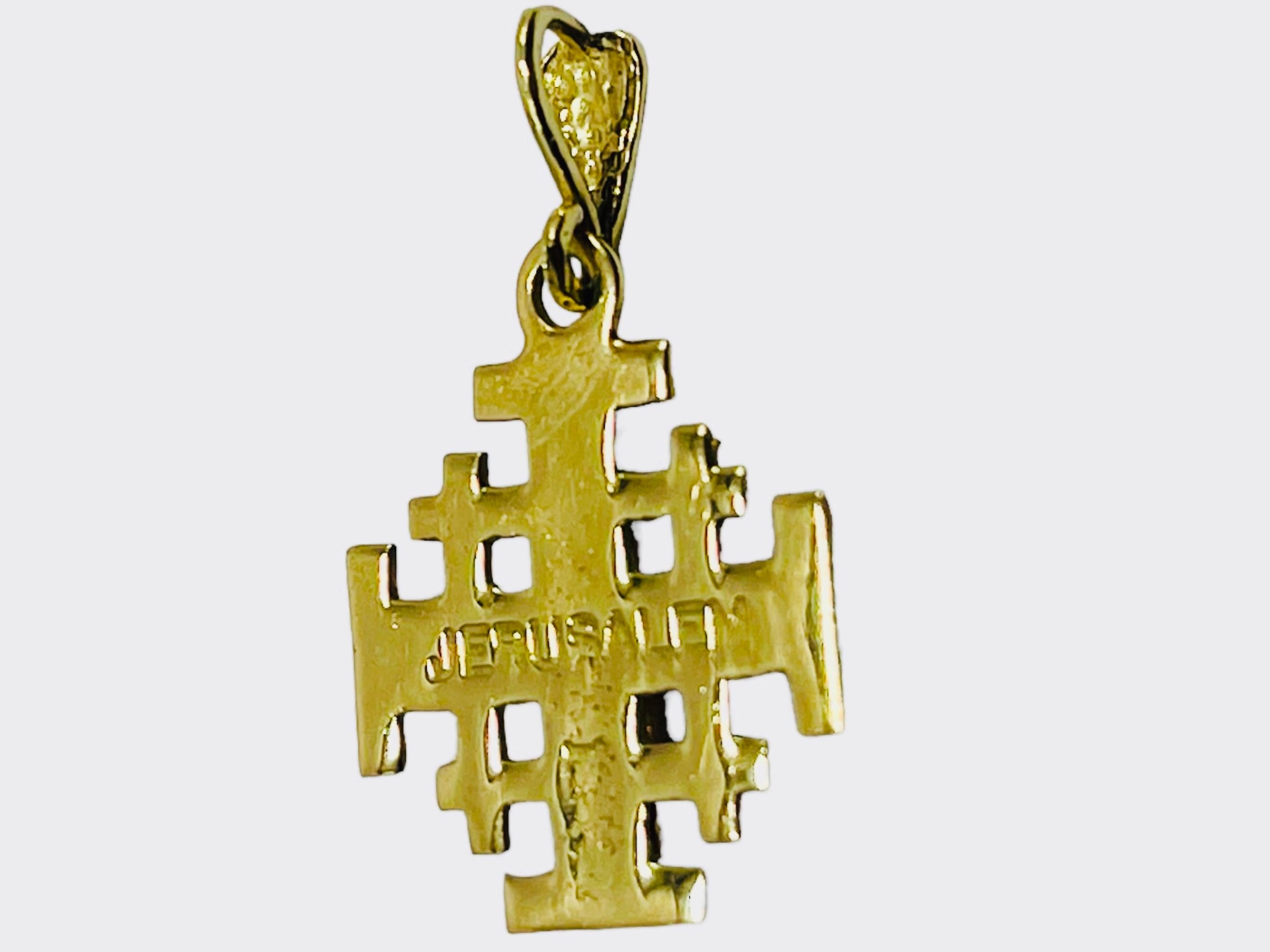 This is a small 14K yellow and rose gold cross of Jerusalem. In the back of the cross is engraved Jerusalem.