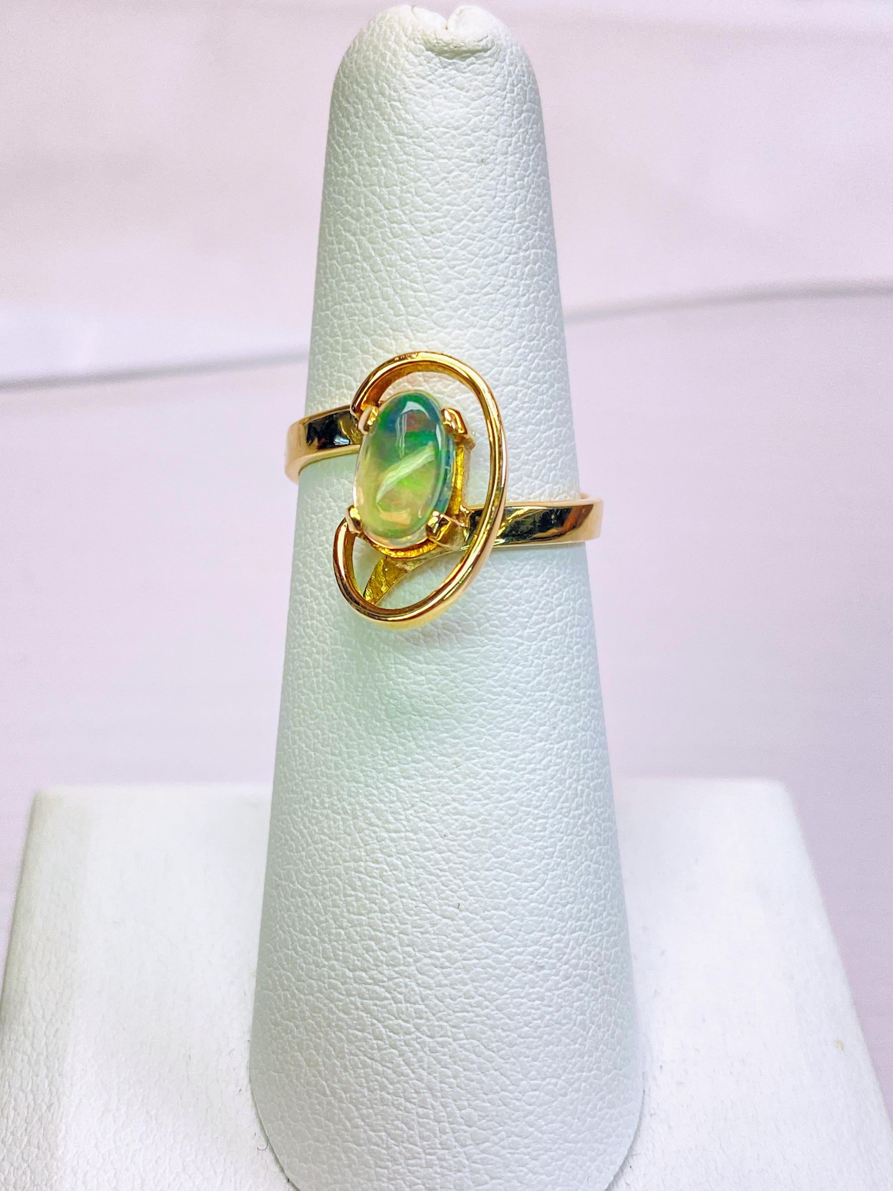 14K Yellow Solid Gold Estate Natural Fire Opal Cosmic Overlay Bypass Ring

This vintage ring exudes timeless charm with its solid 14K yellow gold construction and natural fire opal centerpiece. The cosmic overlay design adds a touch of celestial