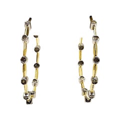 Boucles d
oreilles en or jaune et blanc 14k avec diamants de .32 carats