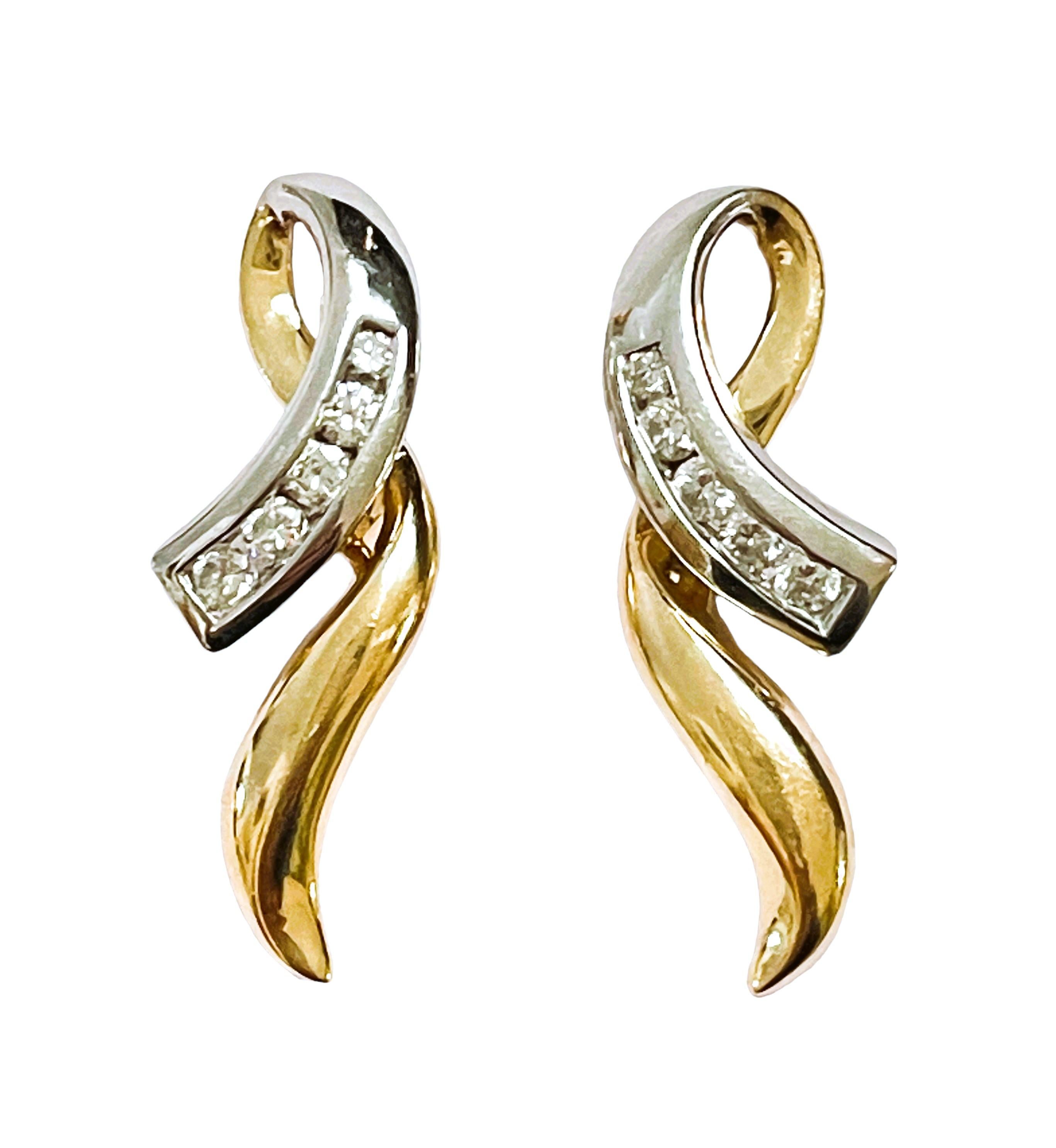 This is a gorgeous pair of Diamond Earrings.   Very well made.  You will be proud to wear these.  They are pre-owned but in just beautiful condition.  I love the shape of them and the fact that they are both White and Yellow Gold. They are post